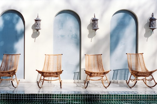 Four chairs by arched windows with lanterns