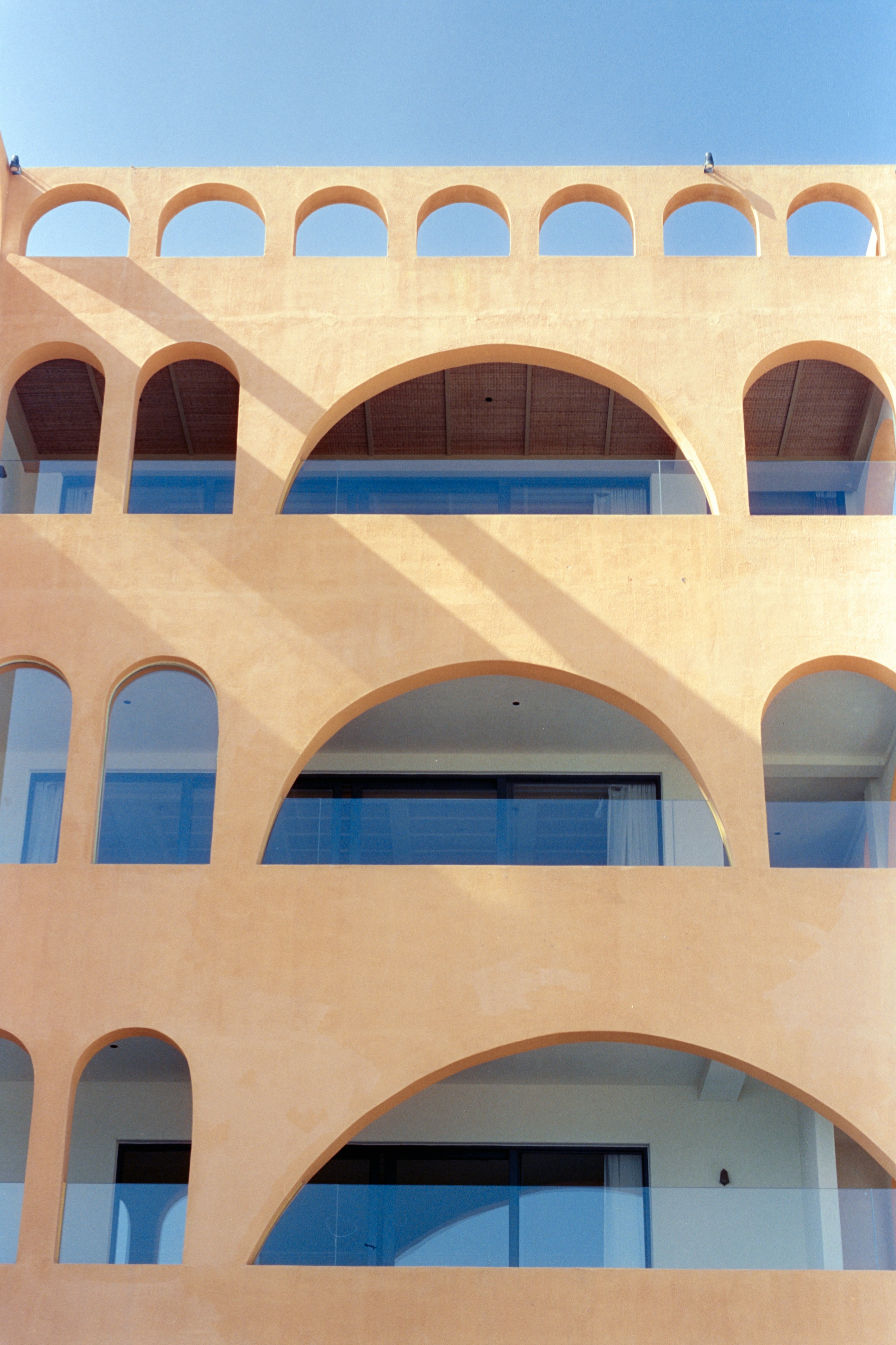 Modern building with arched balconies and blue sky