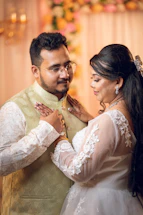 A bride and groom embracing during a wedding ceremony.