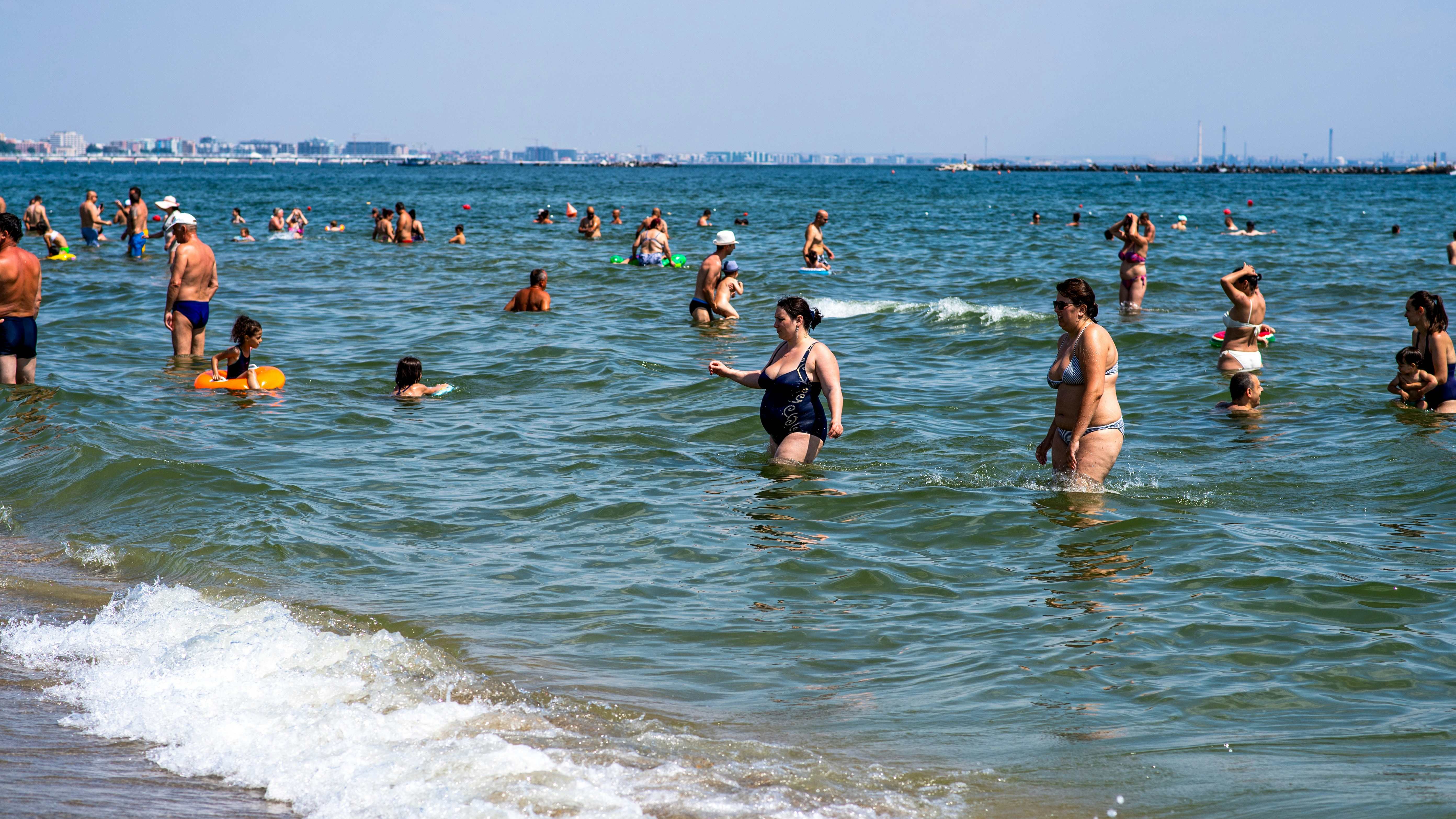 Group of people enjoying beach activities showcasing body positivity