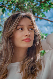 A young woman with long wavy hair outdoors