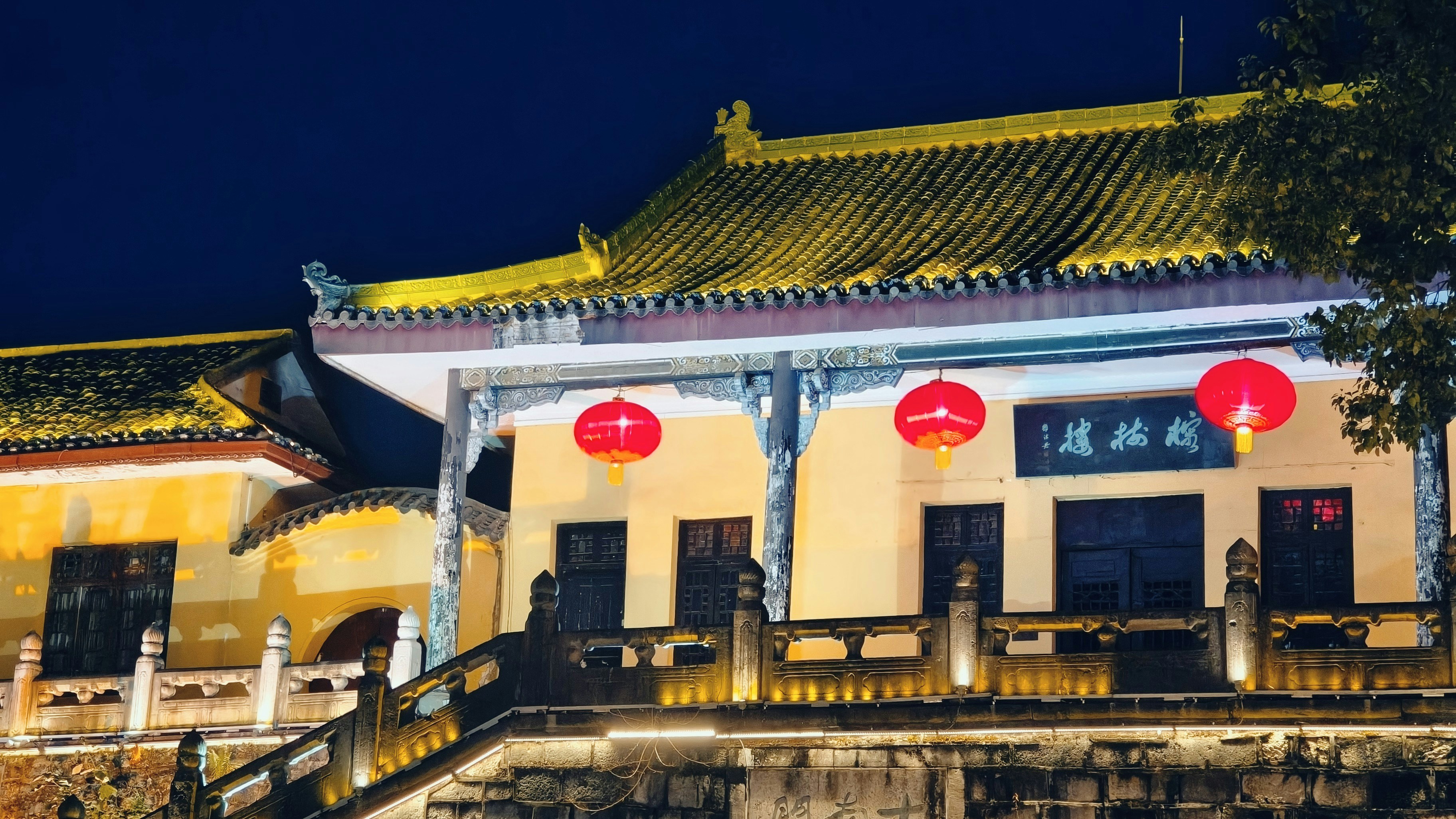 Traditional building with red lanterns at night.
