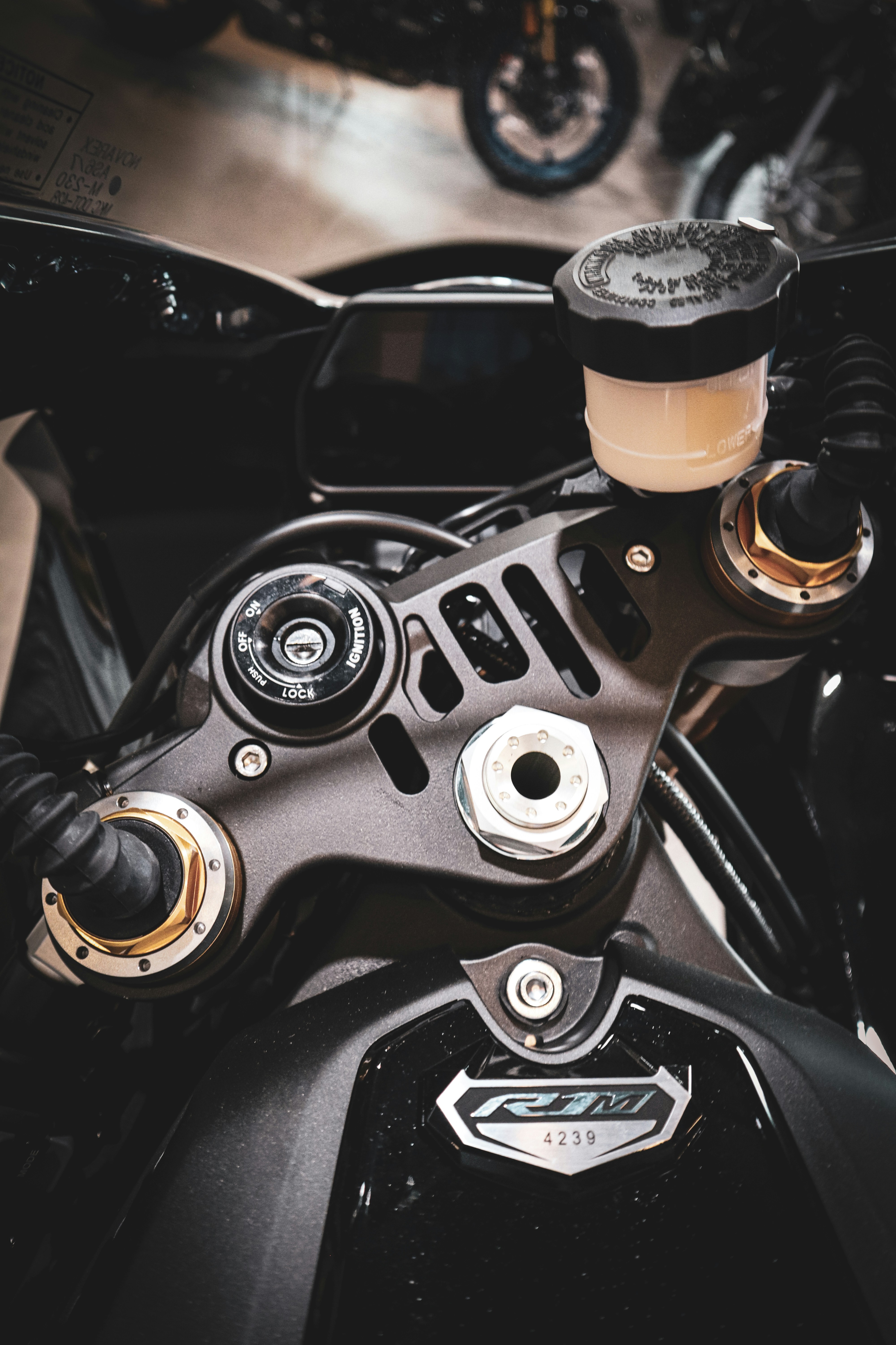 Close-up of a black motorcycle's handlebars and dashboard.