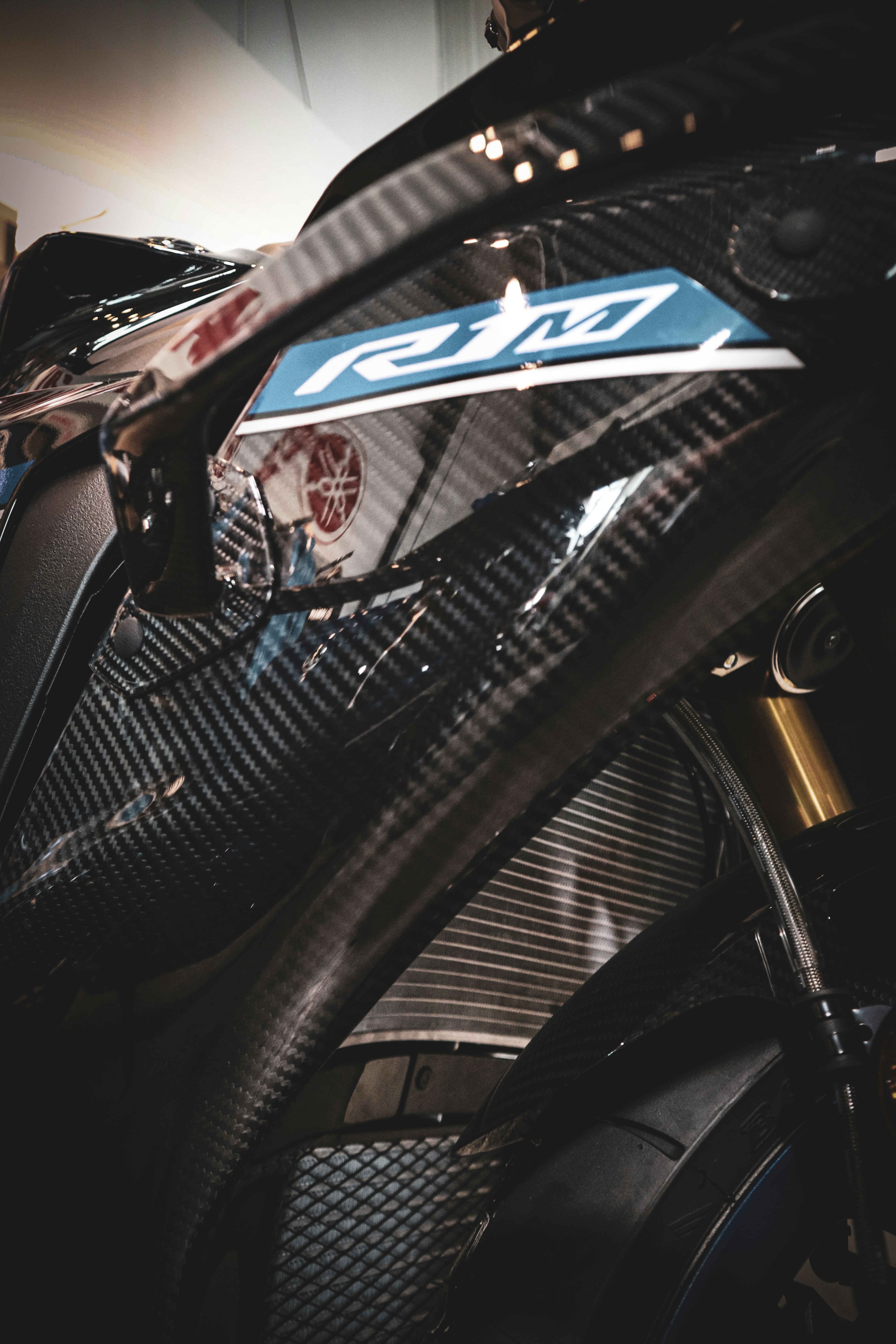 Close-up of a black carbon fiber motorcycle detail.