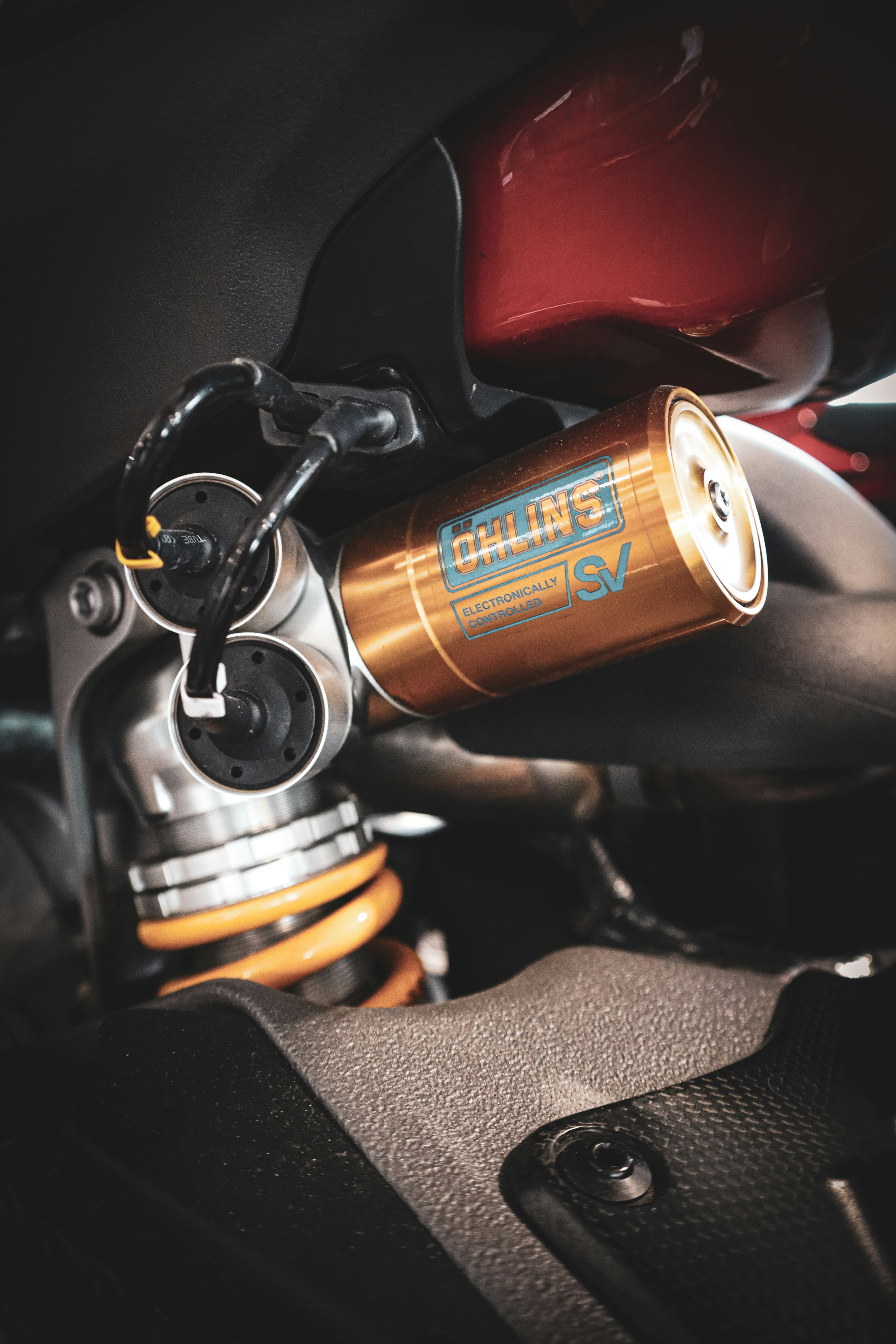 Golden motorcycle suspension with yellow spring detail