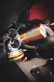 Golden motorcycle suspension with yellow spring detail