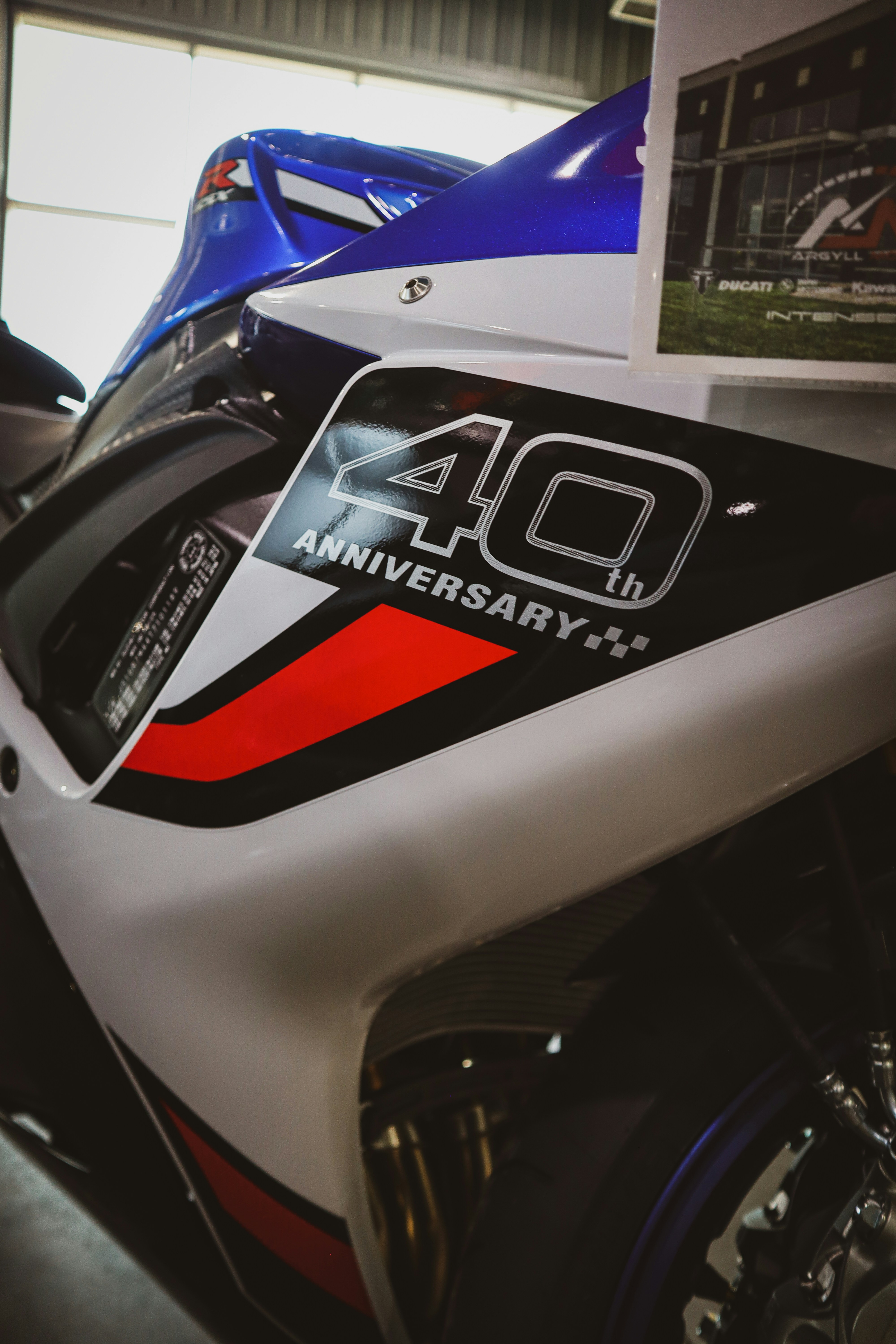 A white motorcycle with a 40th anniversary decal.
