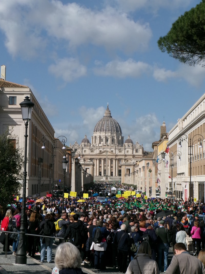 Crowd gathers in front of St Peter's Basilica in Rome