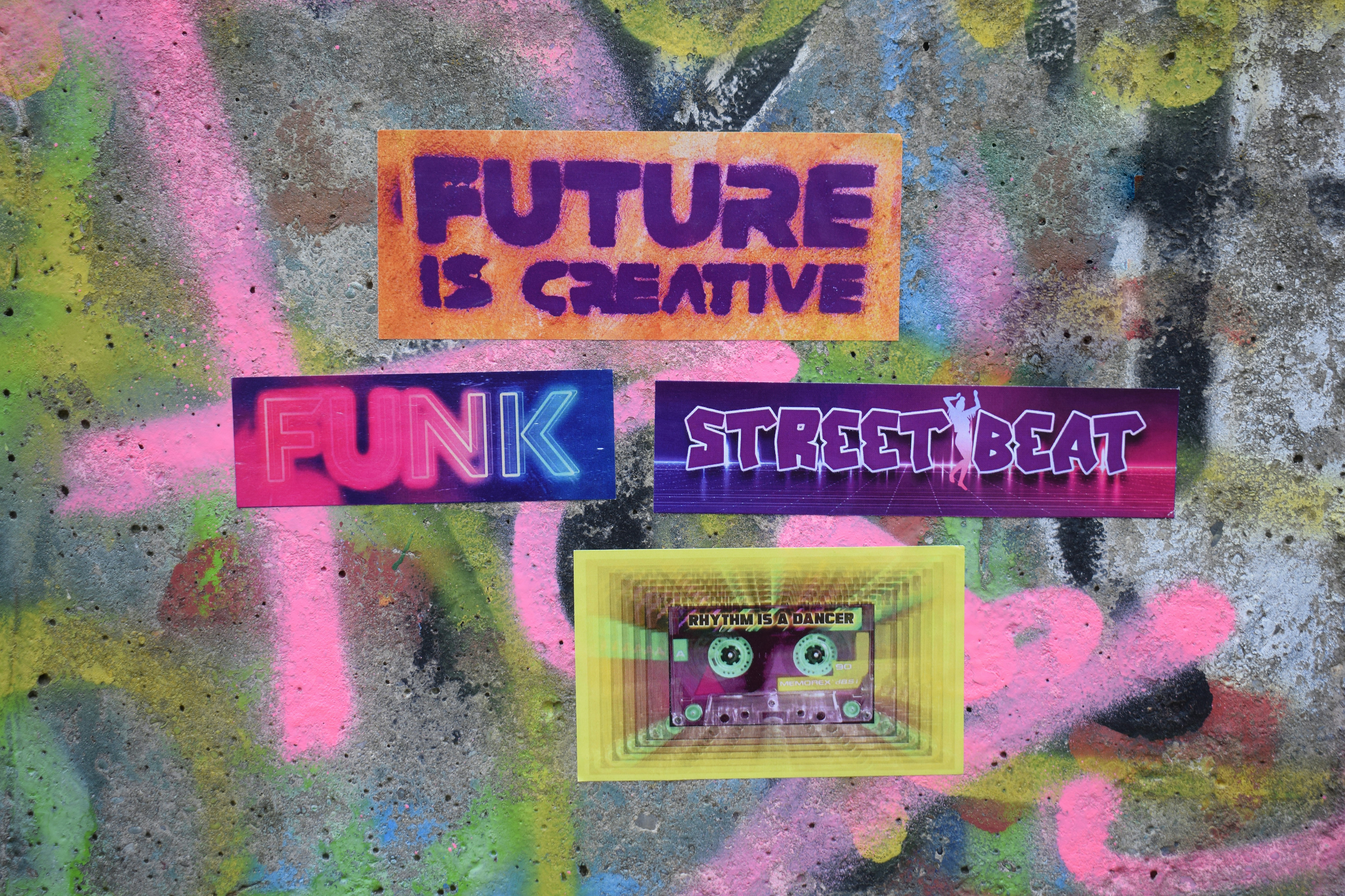 Graffiti art with colorful "future is creative" stickers.