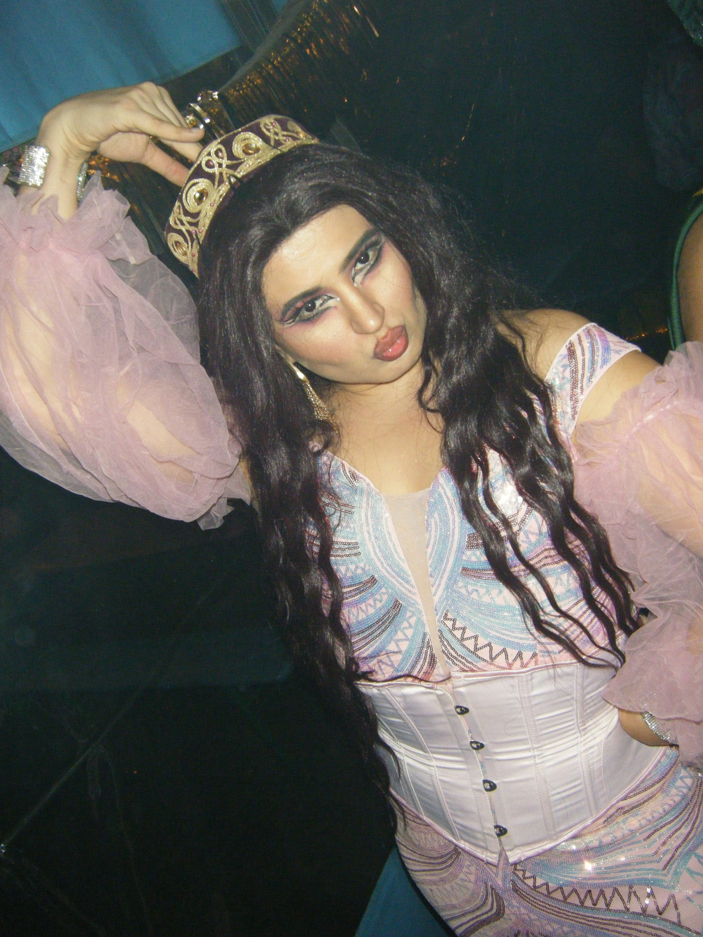 Woman in costume wearing a crown and kissing