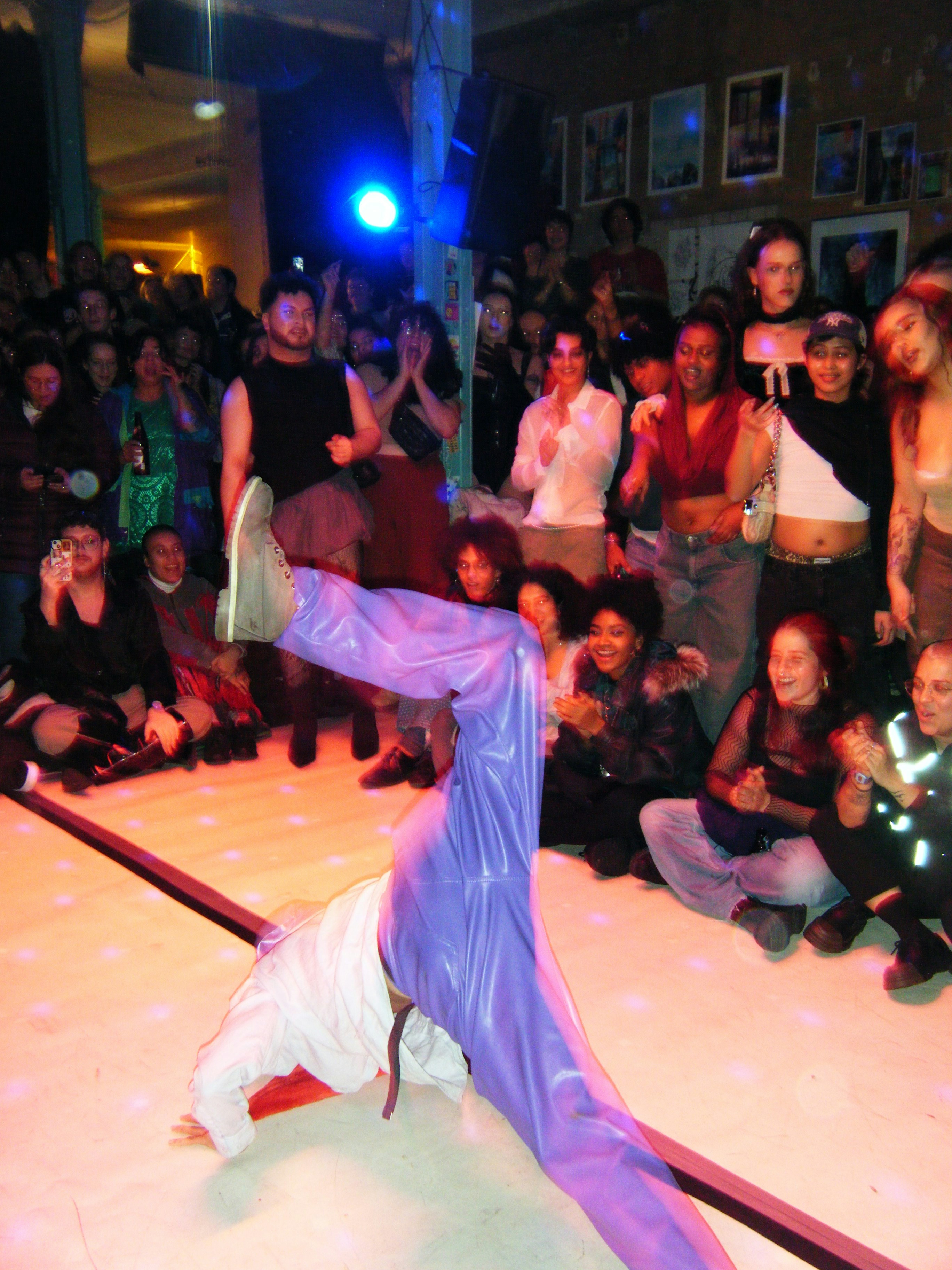 Breakdancer performs for an enthusiastic crowd.