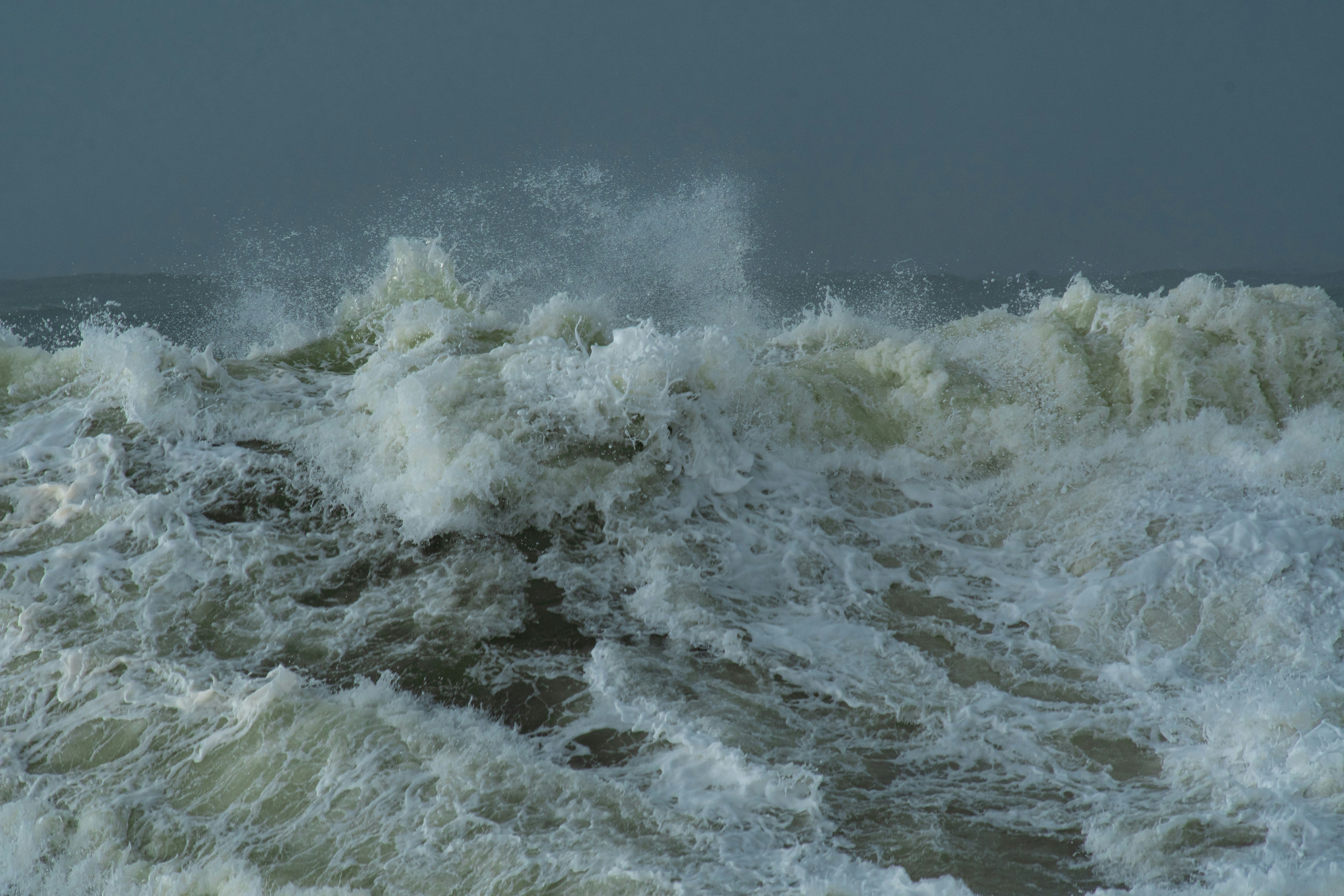 Crashing ocean waves under a stormy sky