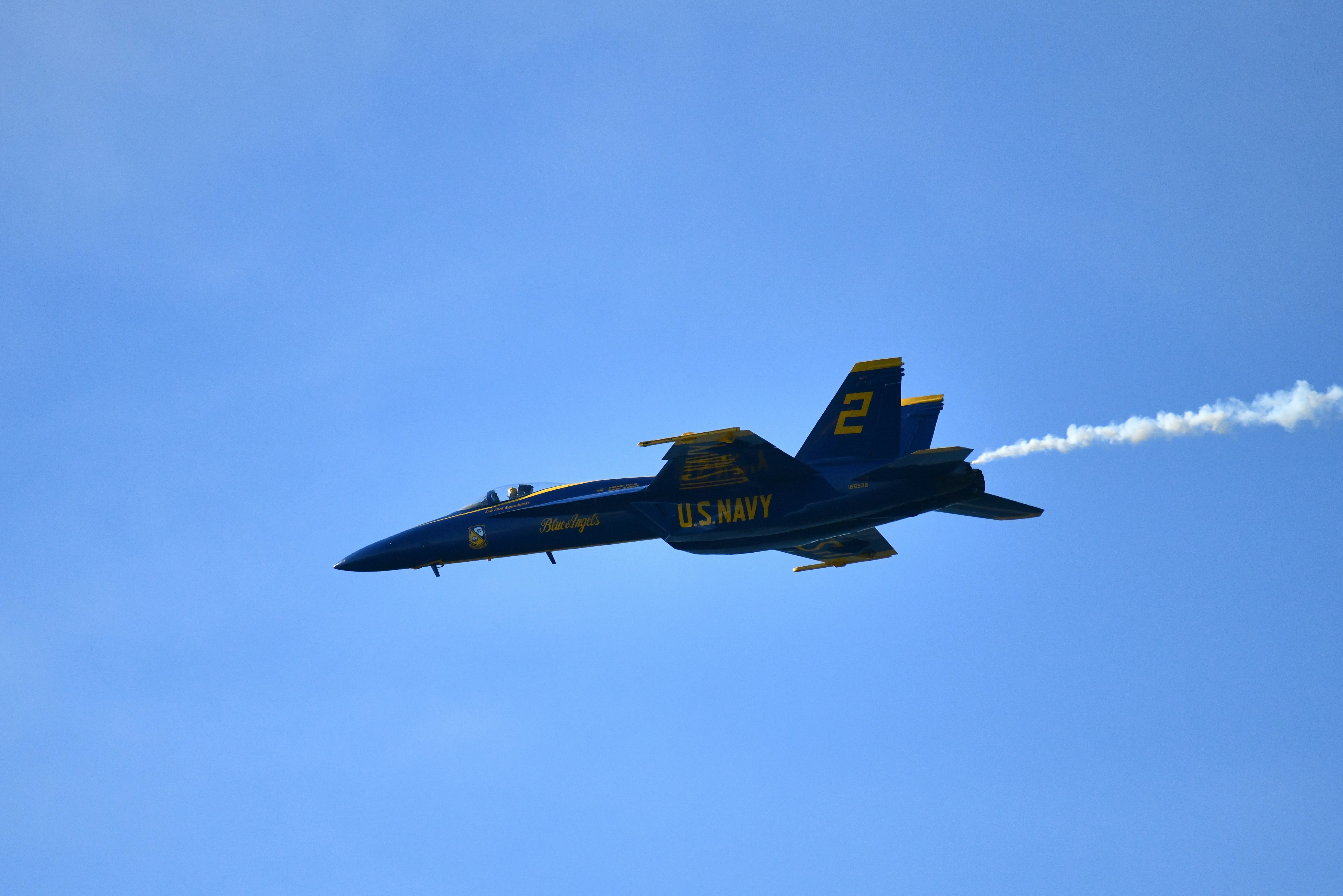 Blue angels jet flying in a clear blue sky