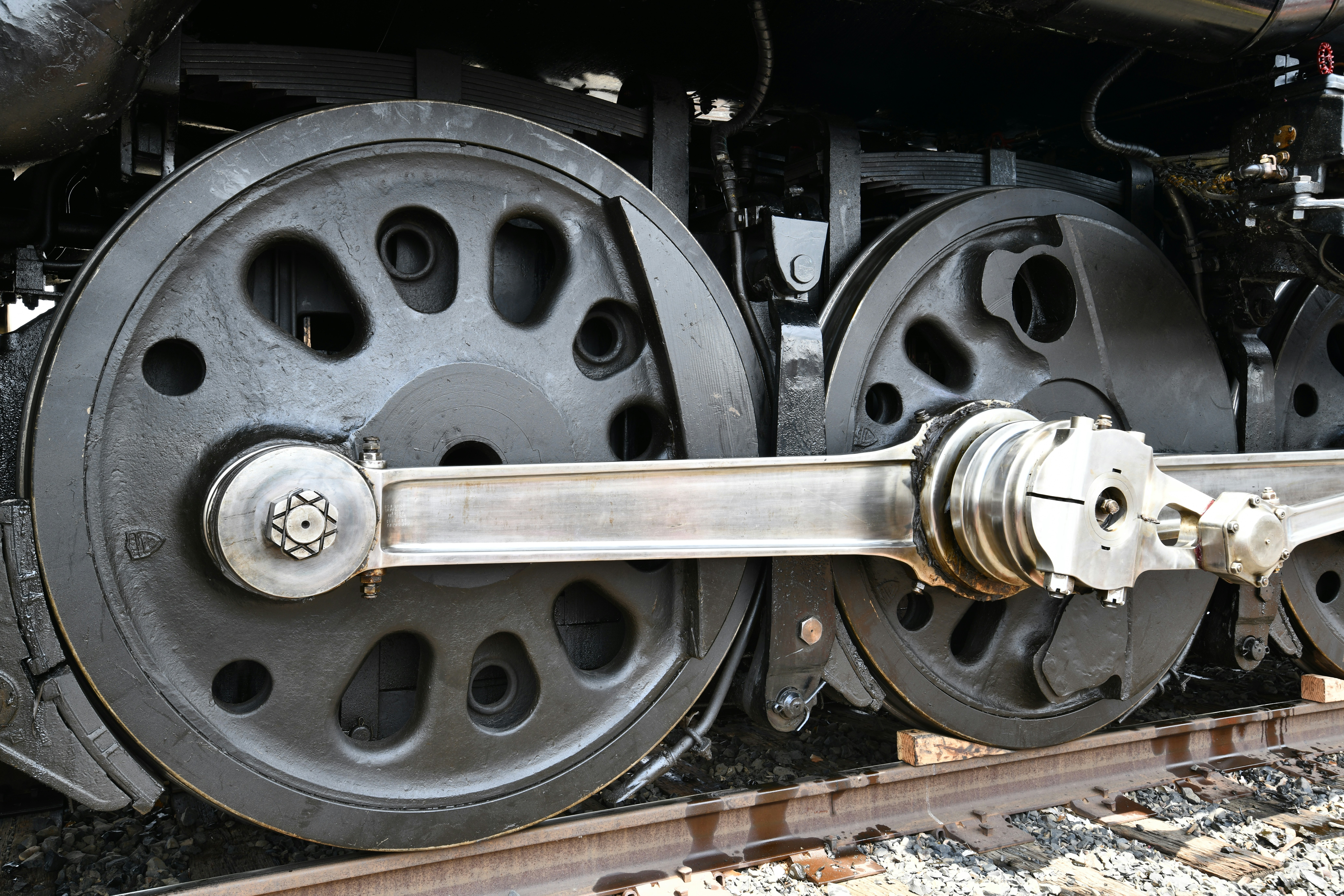 Close-up of large metal wheels on a train.