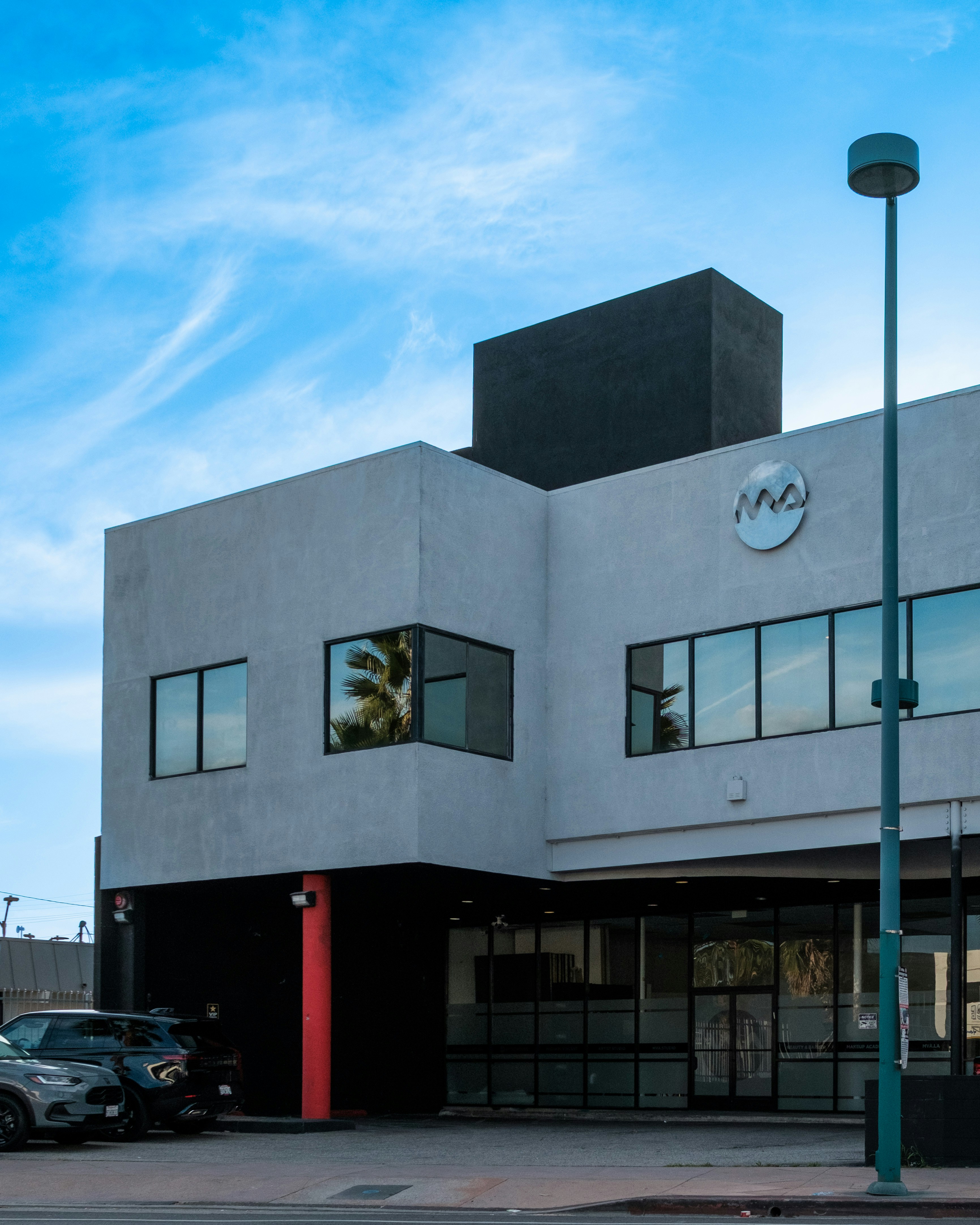 Modern building with glass windows and a street lamp