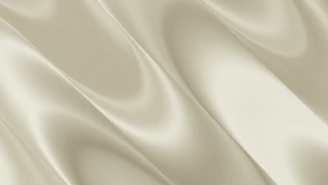 Soft, flowing, light beige fabric with elegant folds
