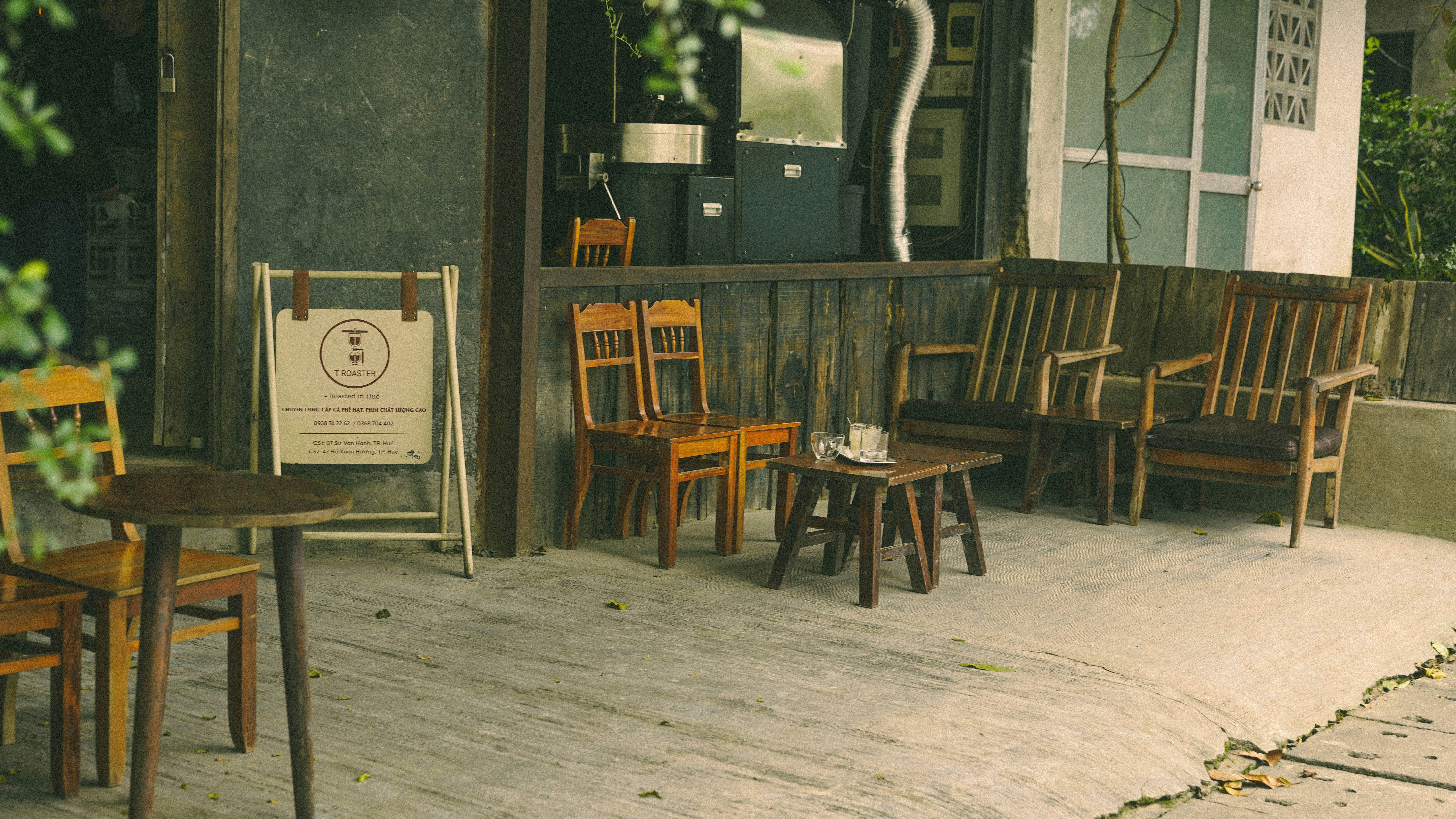 Wooden chairs and tables outside a cafe