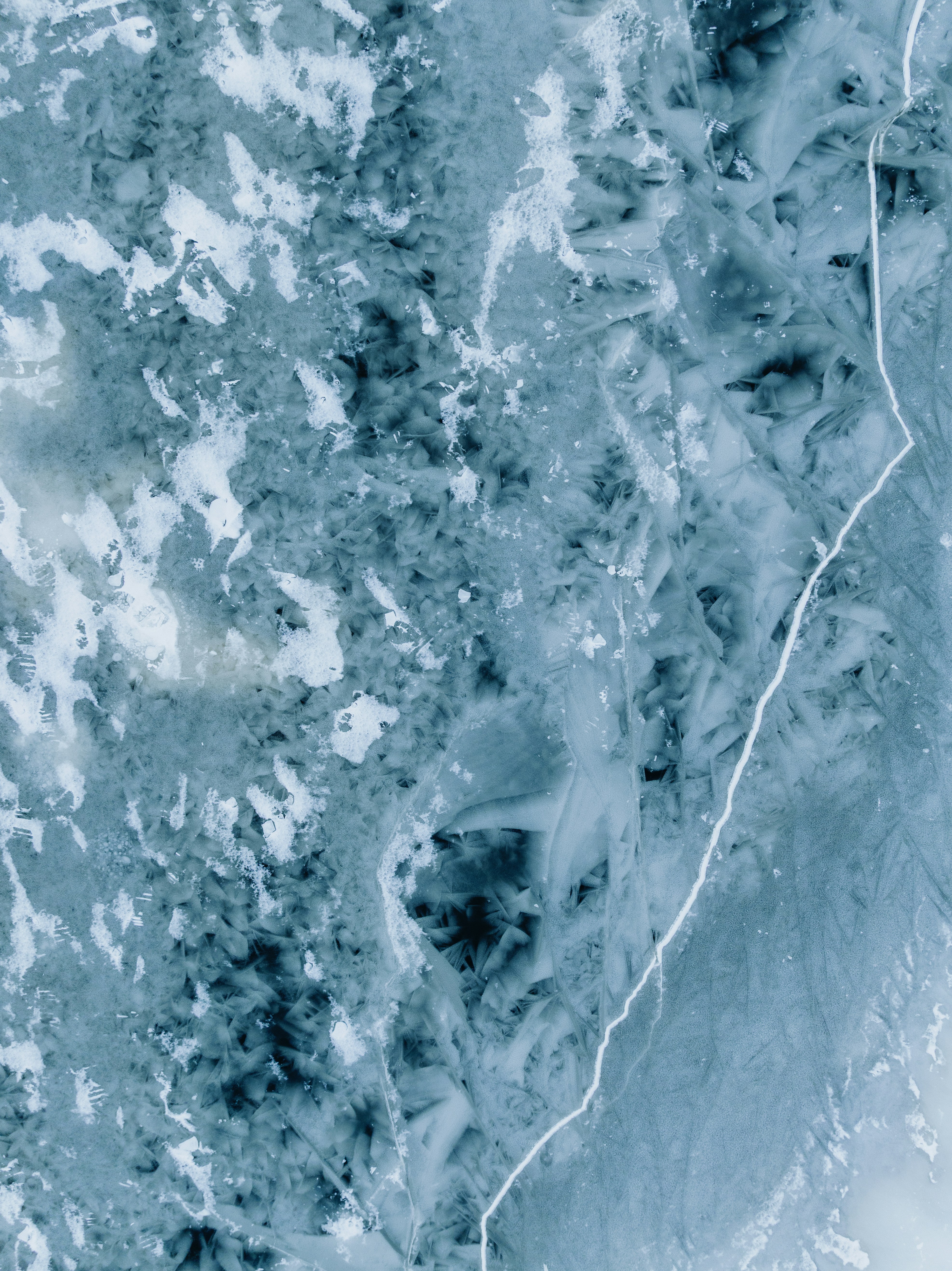 Close-up of ice formations with blue and white patterns.