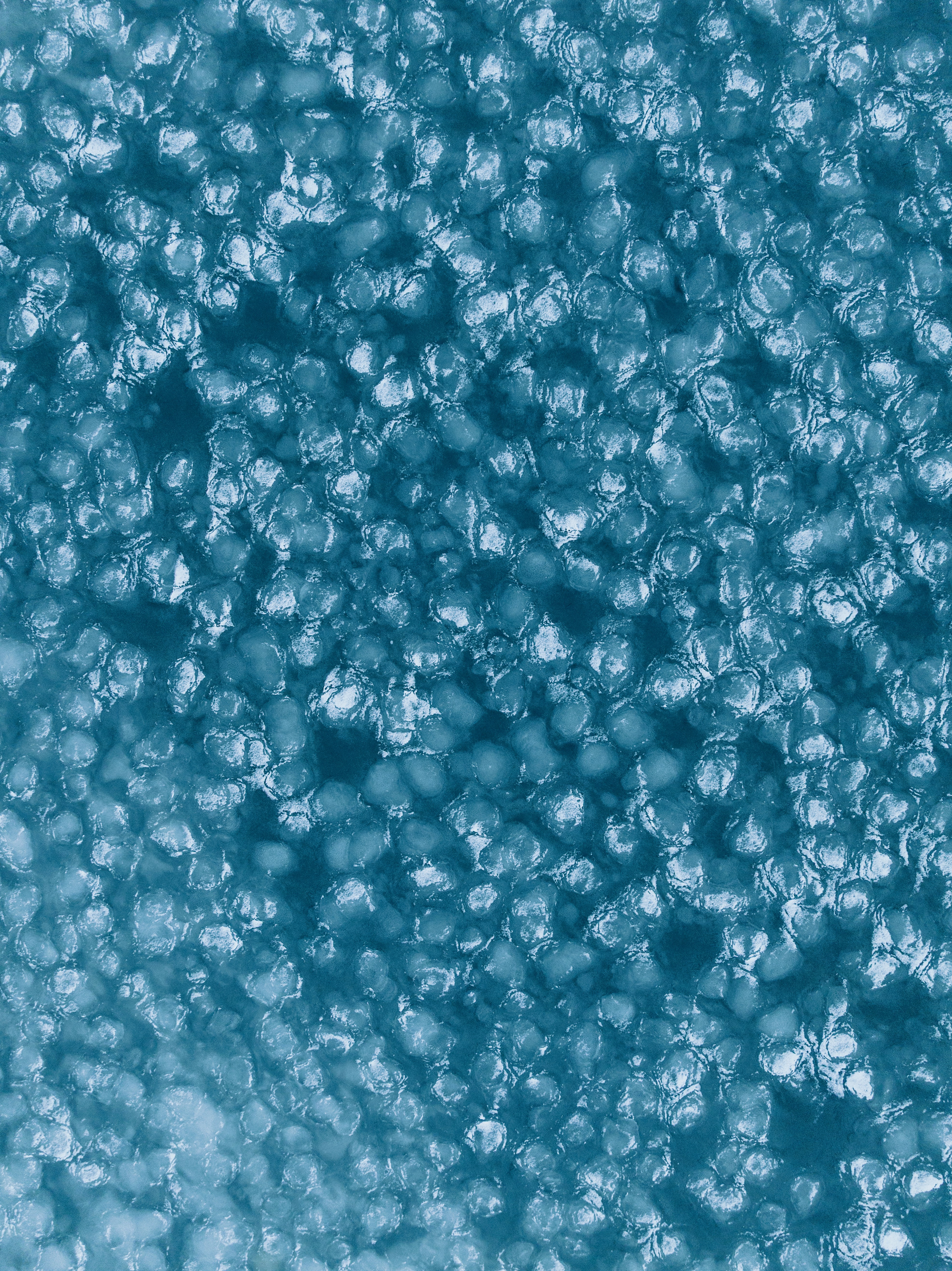 Close-up abstract texture of small, irregular blue shapes.