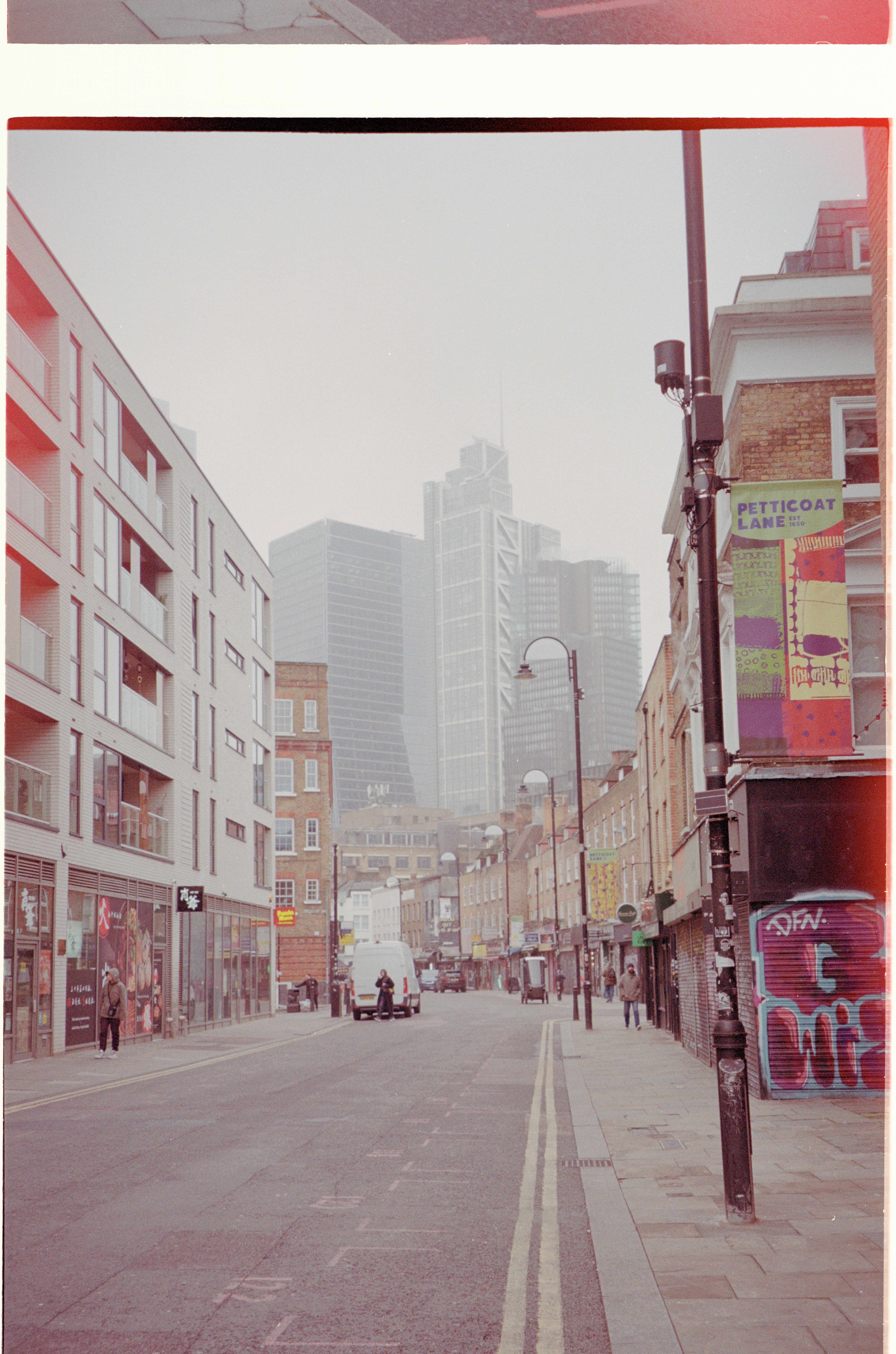 City street with modern and old buildings in fog
