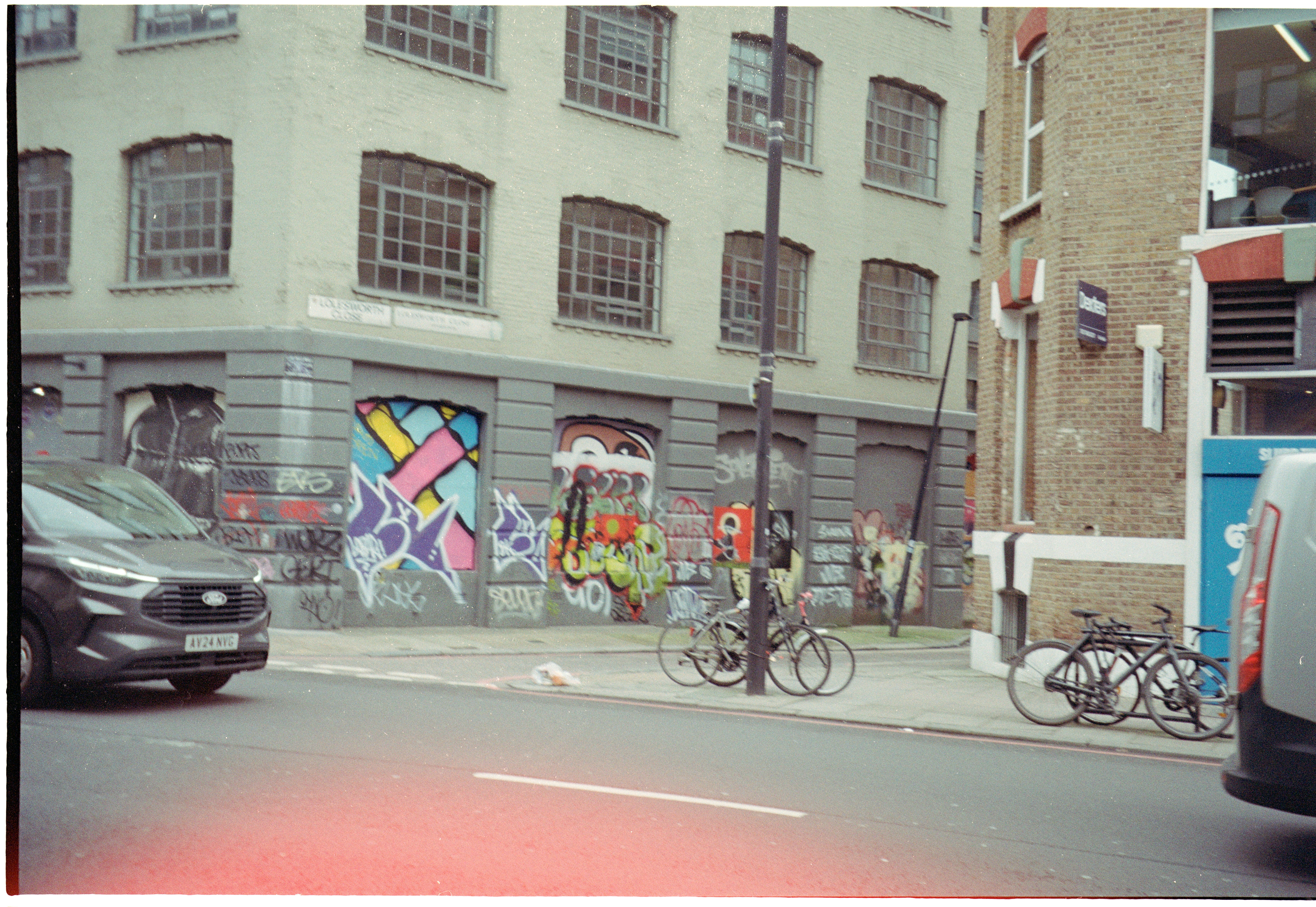 Graffiti art on a building with parked bicycles