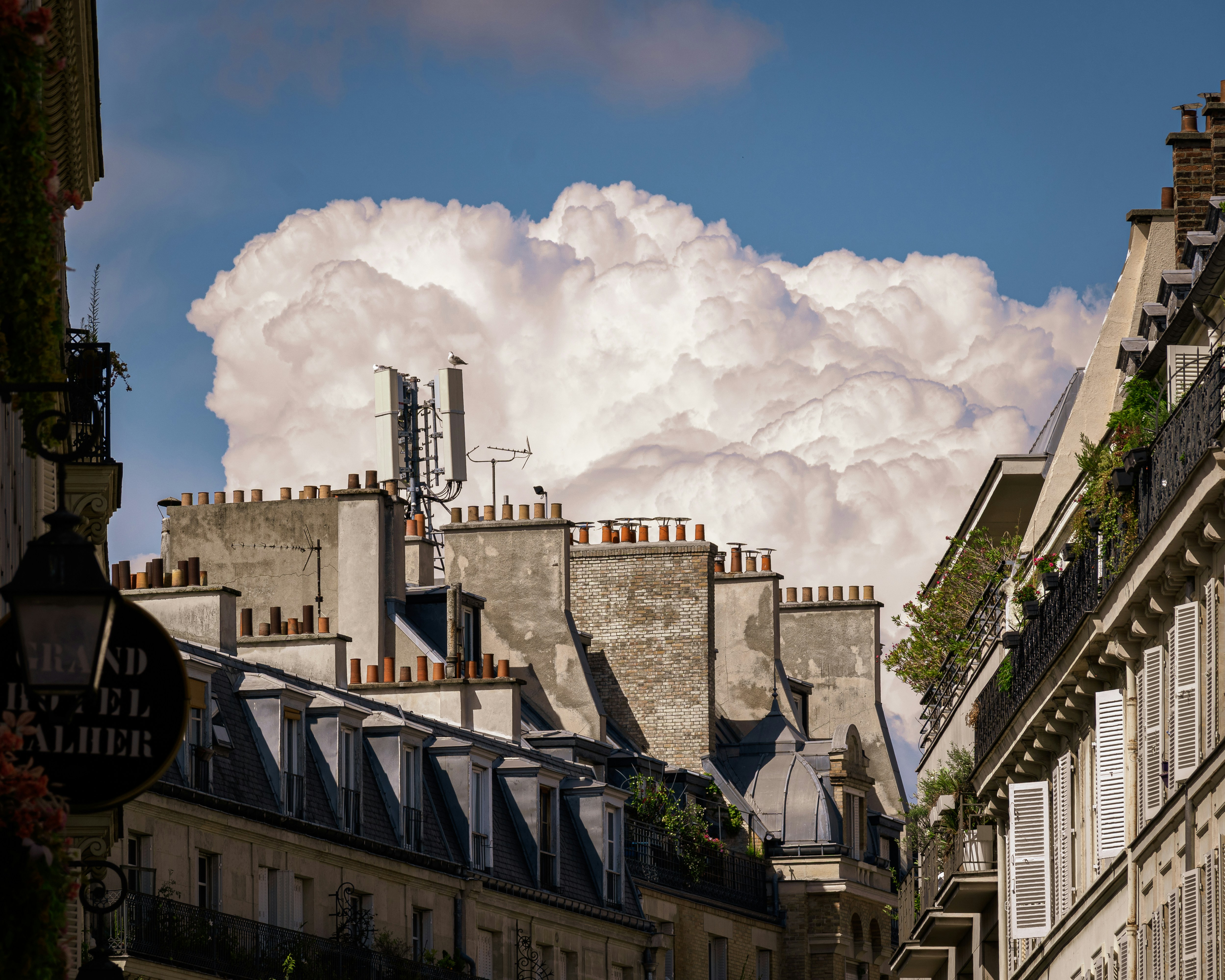 Rooftops and chimneys under a dramatic cloud formation