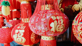 Red chinese lanterns with golden characters hang closely.