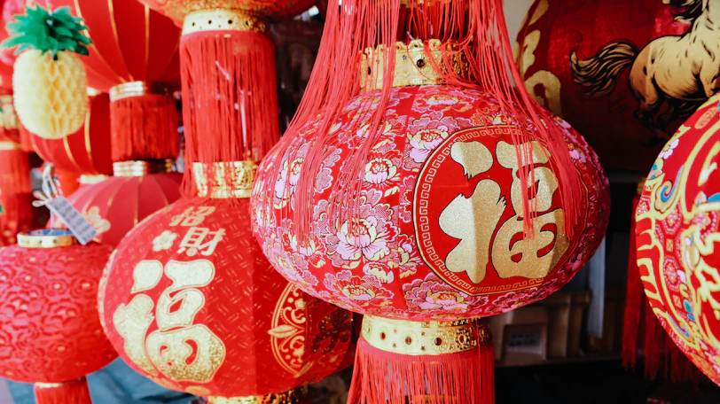 Red chinese lanterns with golden characters hang closely.