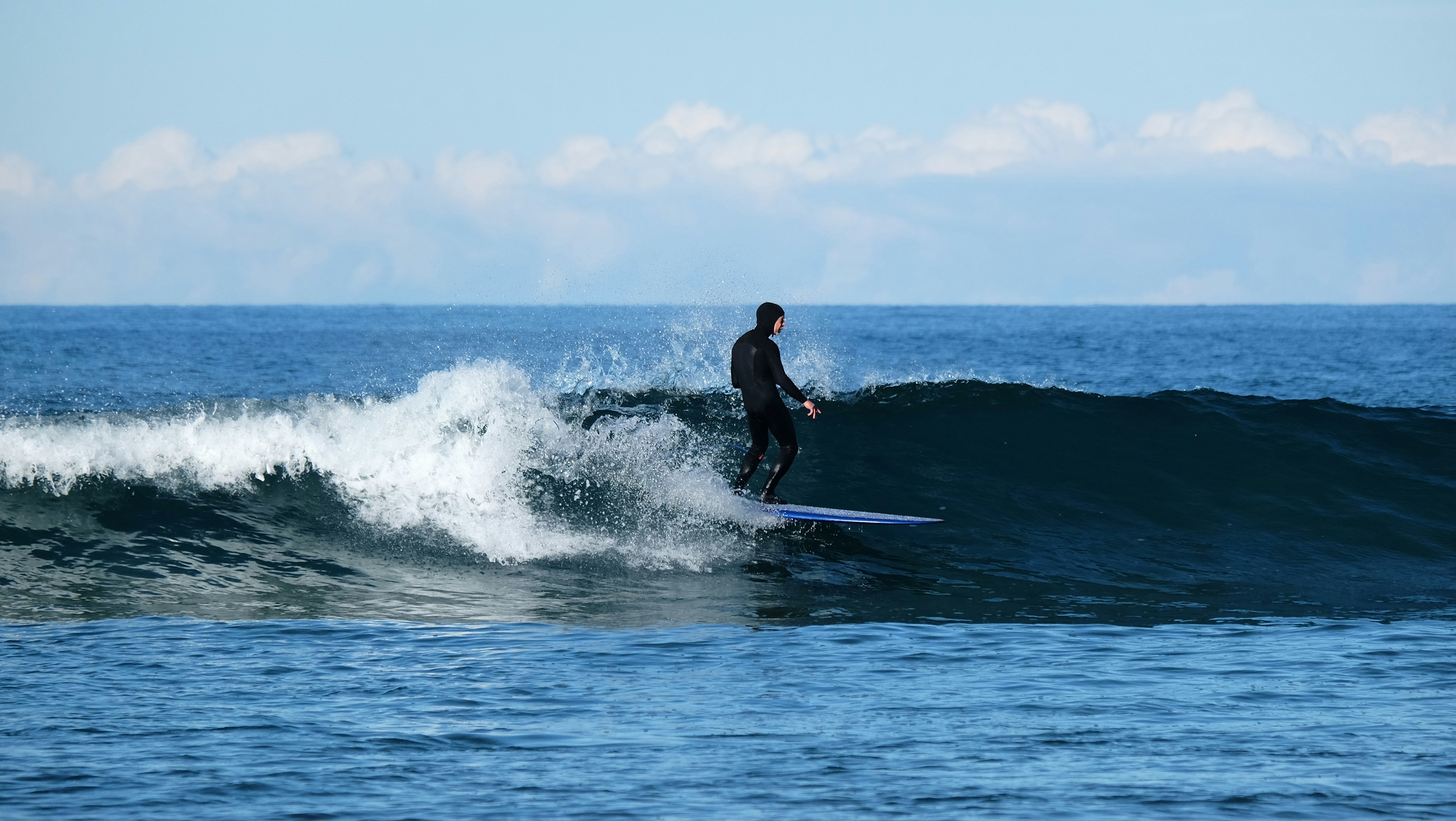 Surfer riding a wave on a sunny day