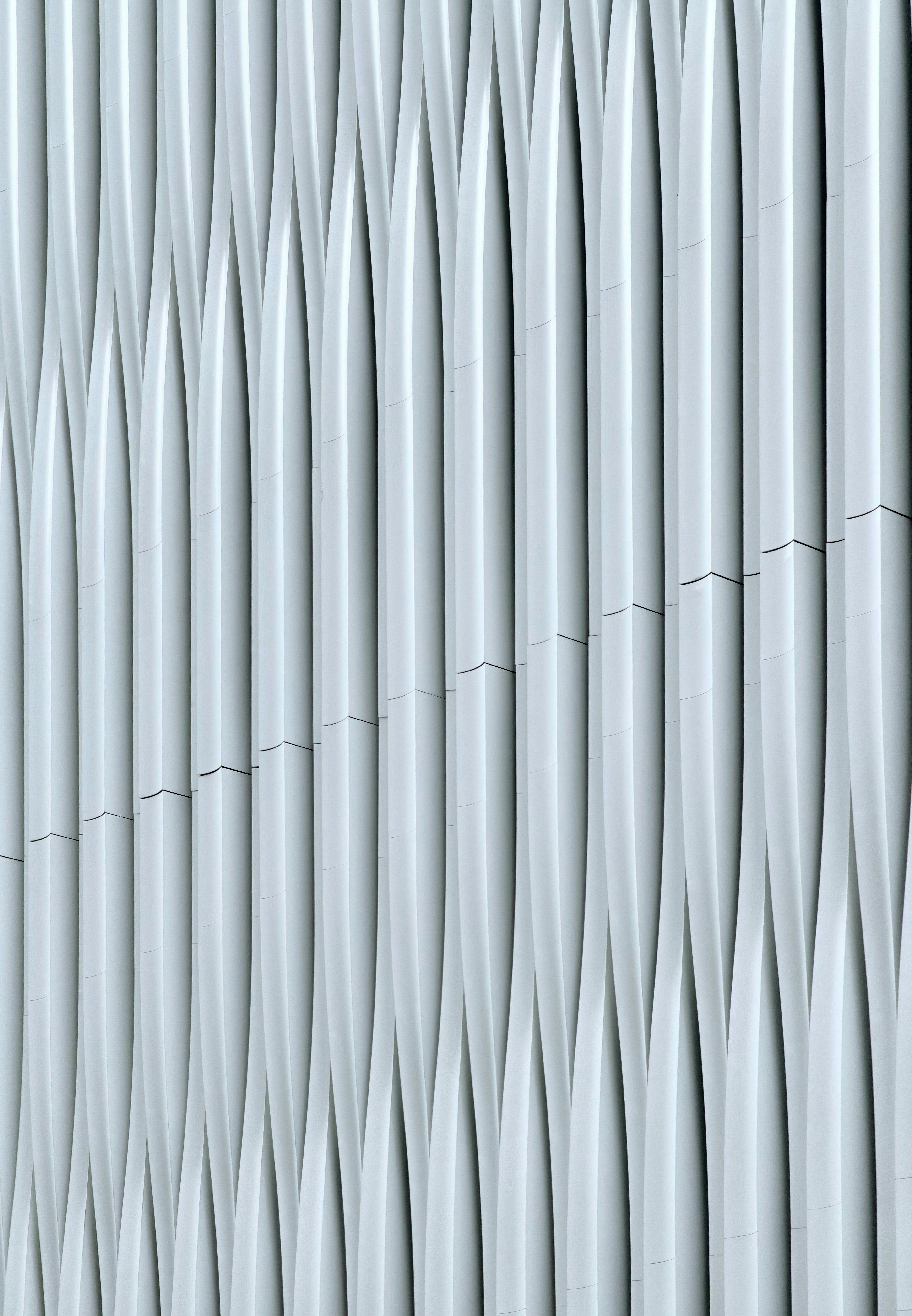 Abstract pattern of white wavy vertical architectural elements