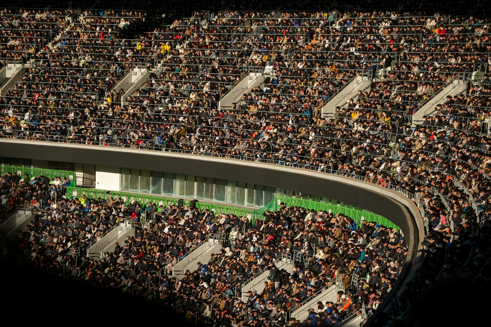 A crowded stadium filled with spectators watching an event.