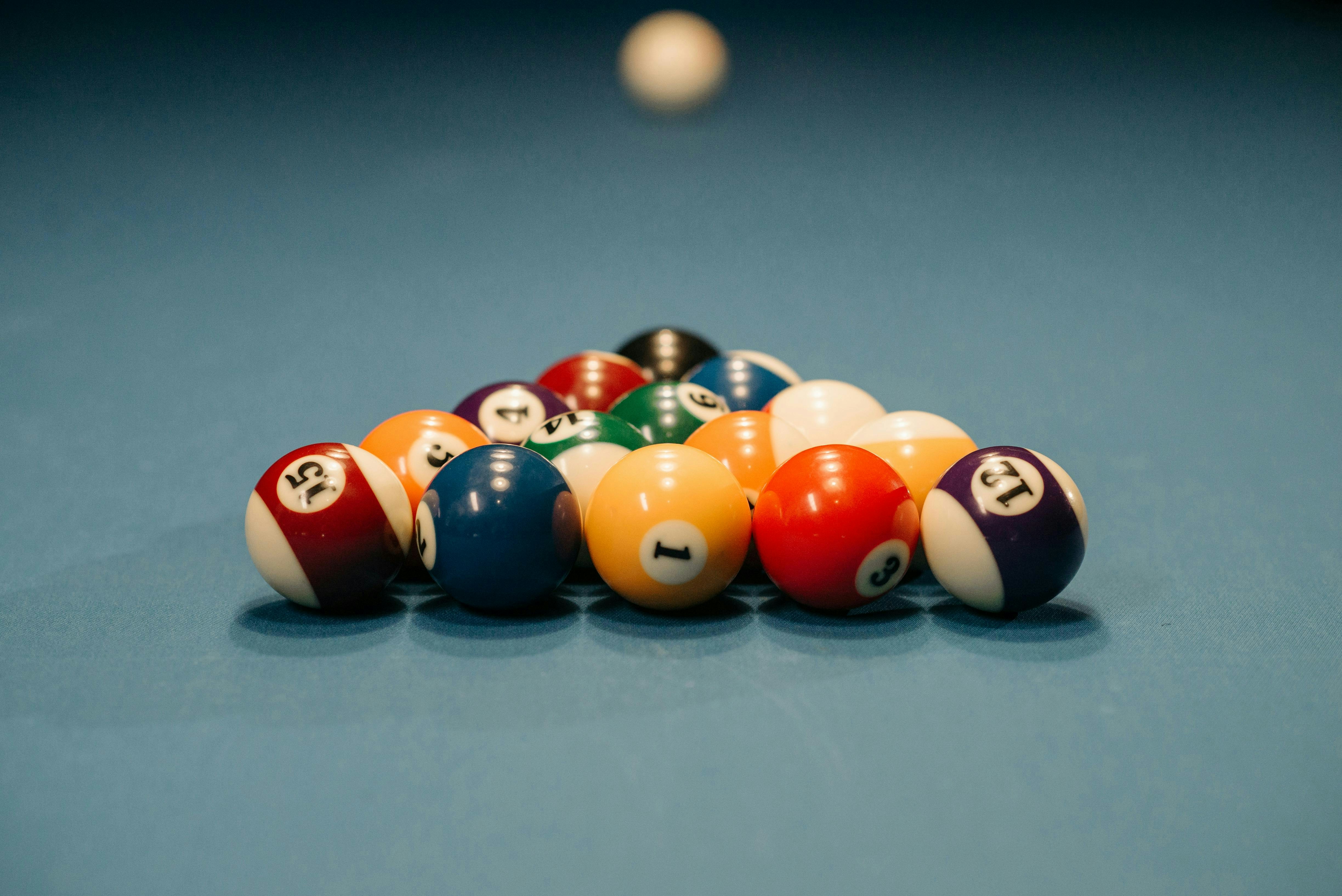 Billiard balls racked on a blue felt table.