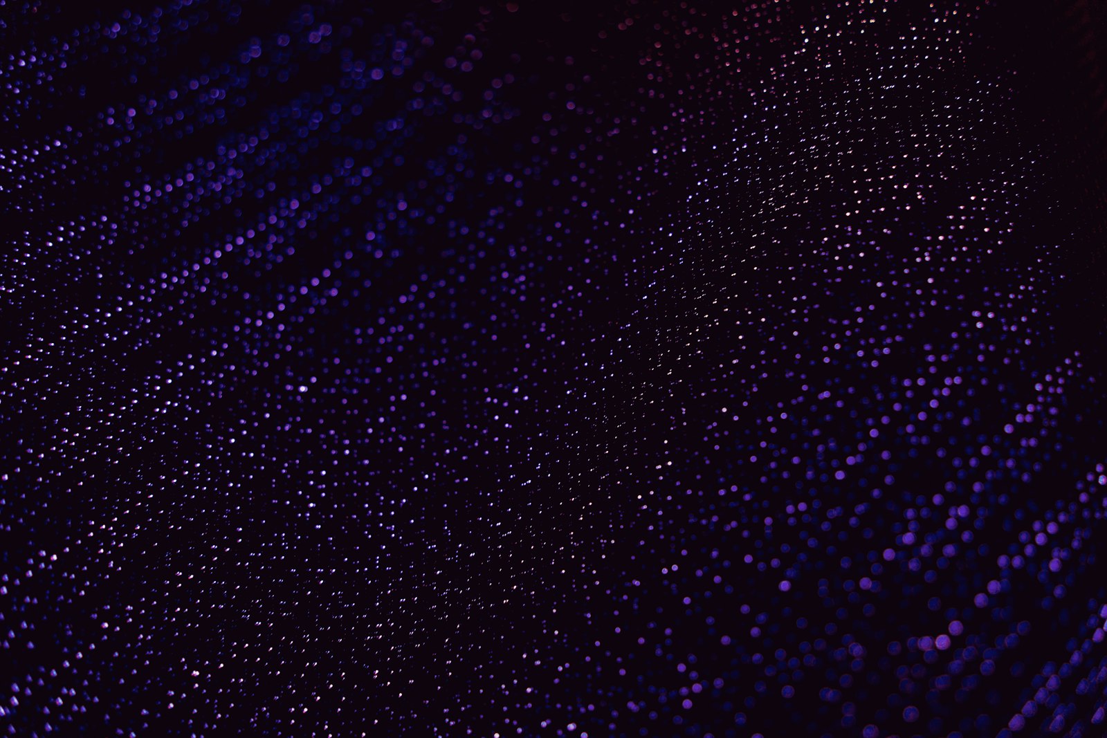 Abstract pattern of small lights on dark background