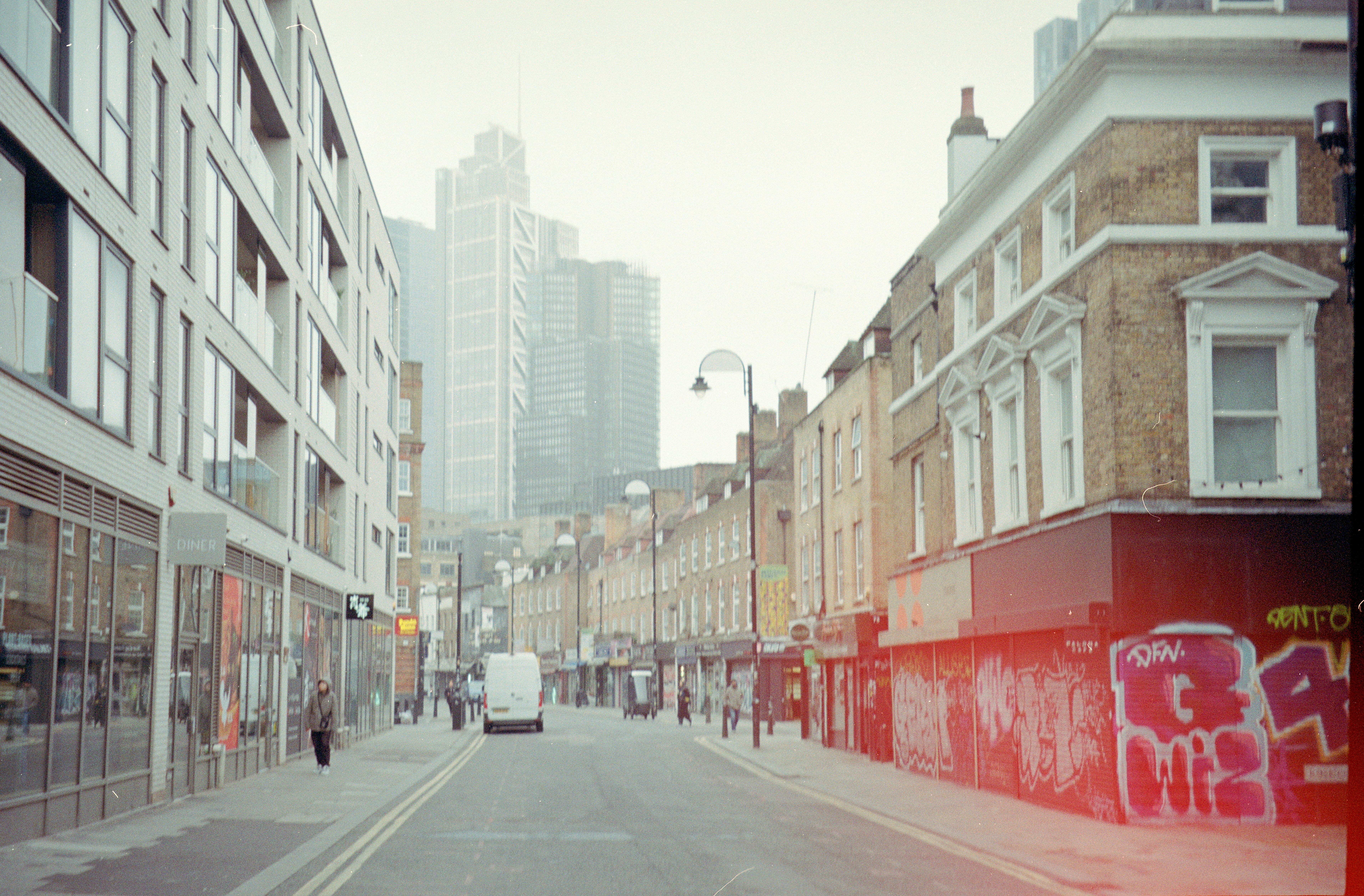City street with modern and old buildings, graffiti.