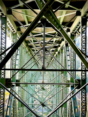 Intricate metal framework of a large green bridge