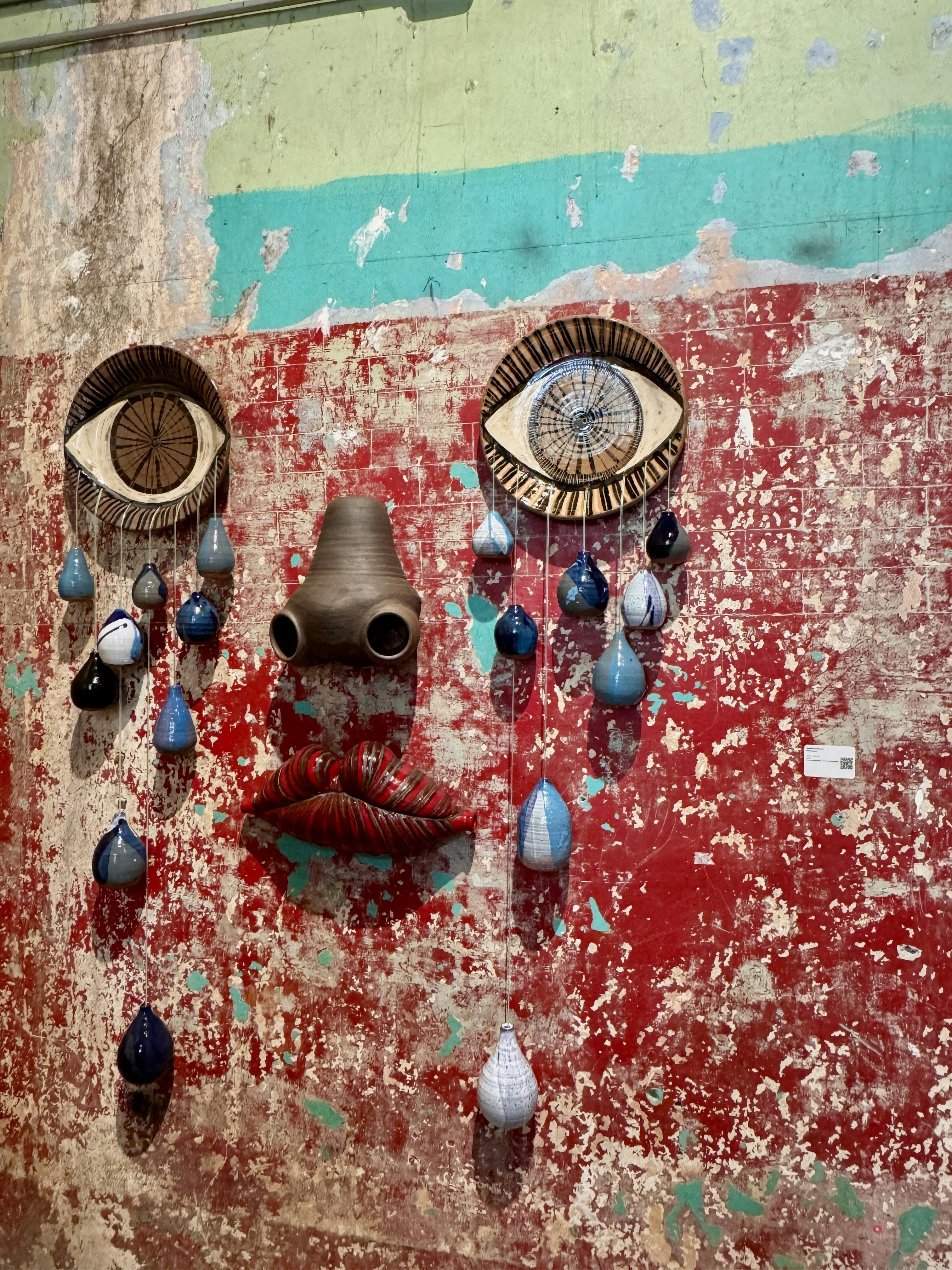 Abstract art installation resembling a face with tears