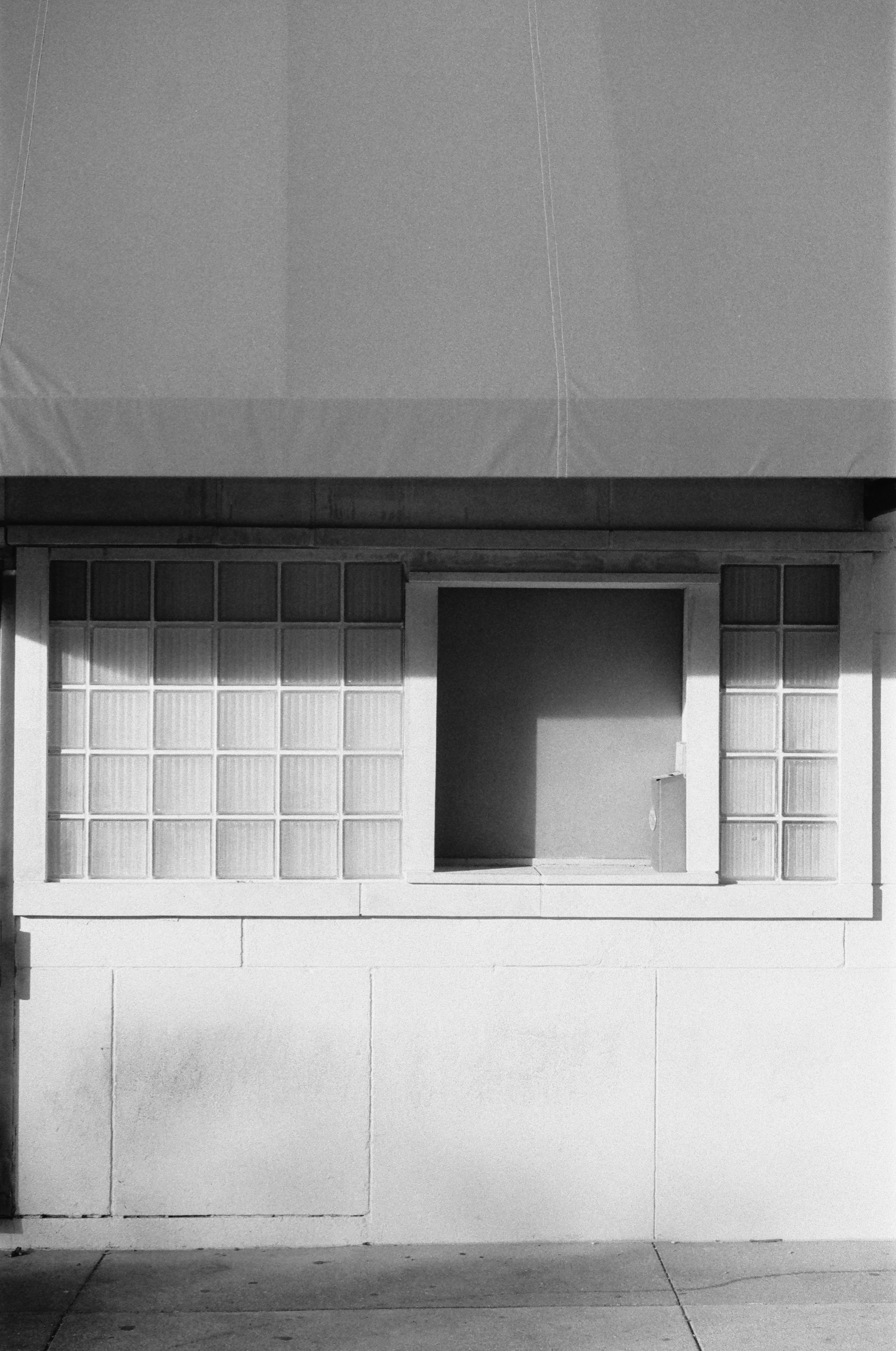 Glass block windows on a white building facade