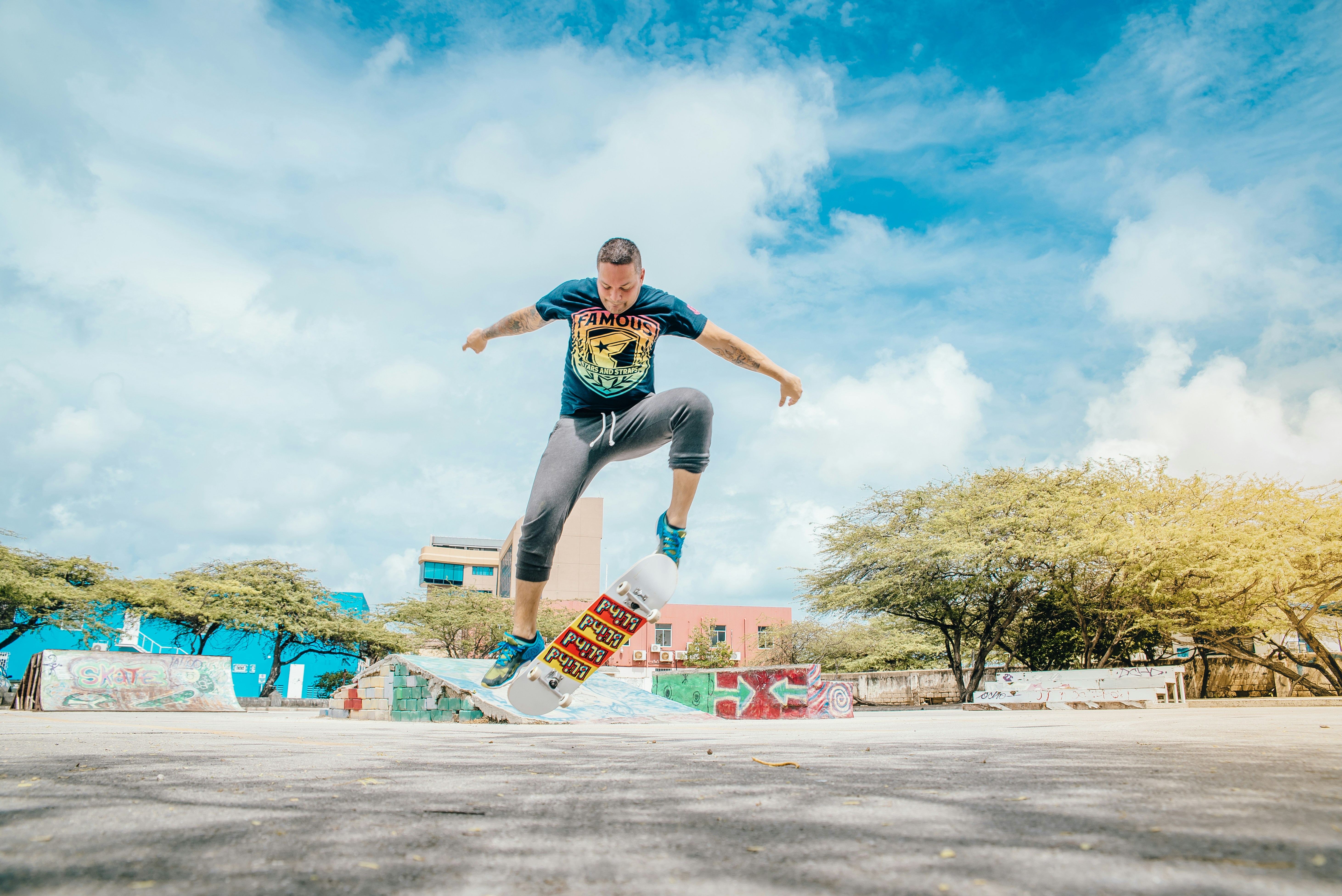 Skateboarder performing a trick in a colorful skate park