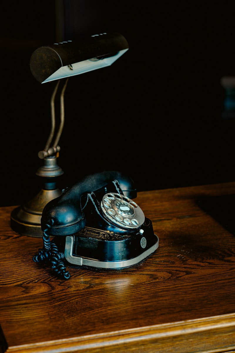 Desk with phone, notebook, and coffee during a long call