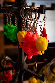 Colorful dragon-shaped keychains hanging on display.