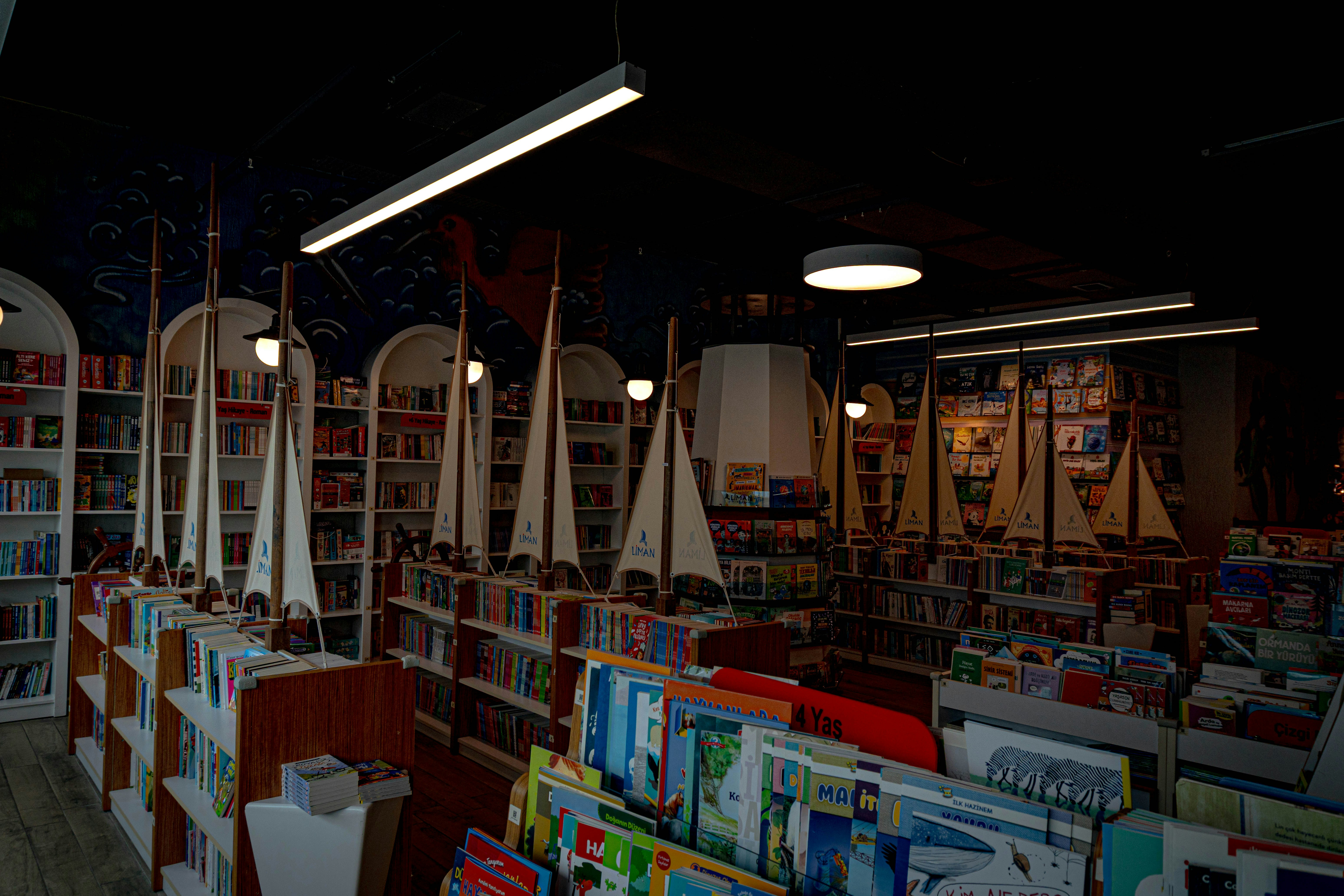 A bookstore interior with model sailboats and bookshelves.