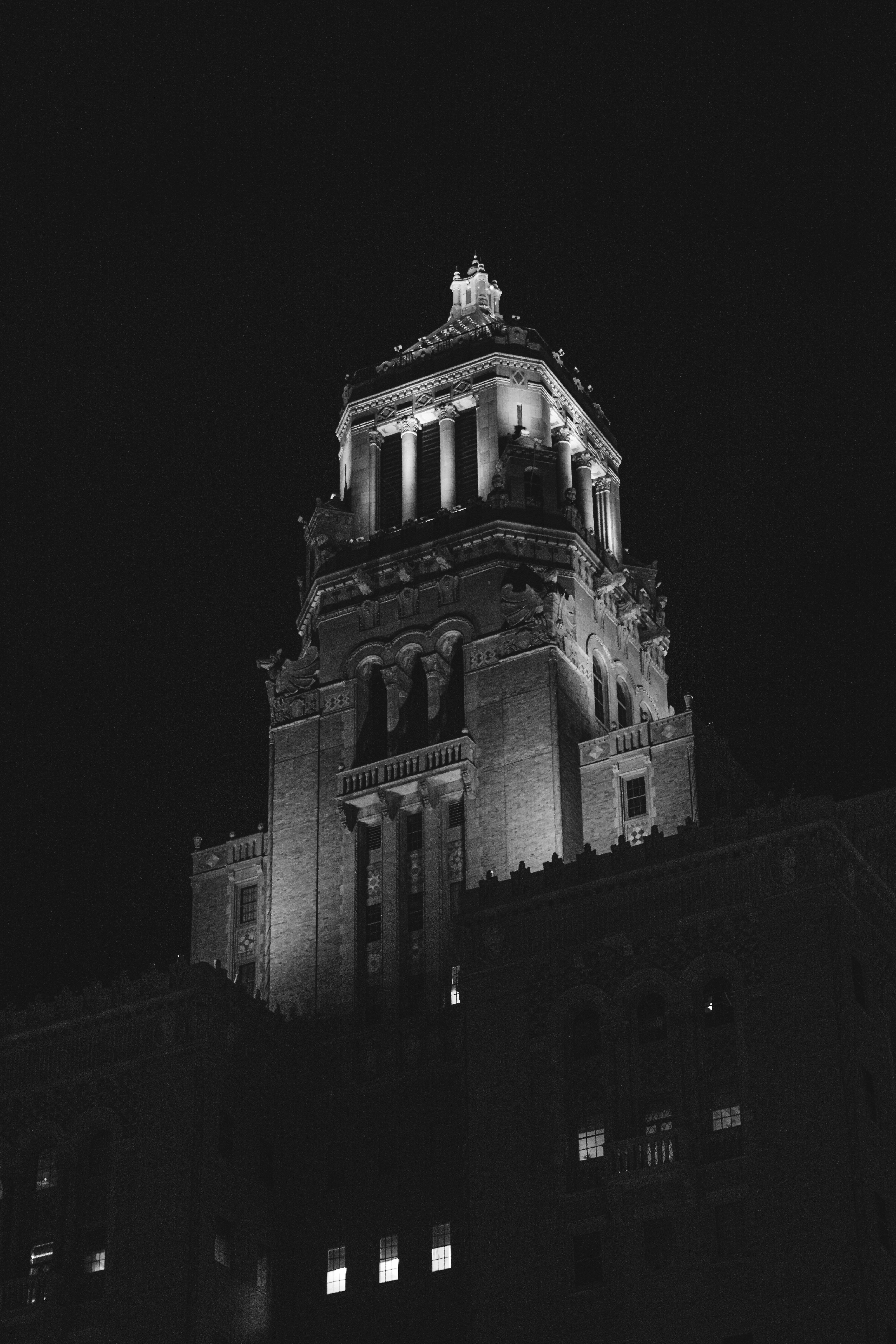 Ornate building tower illuminated at night
