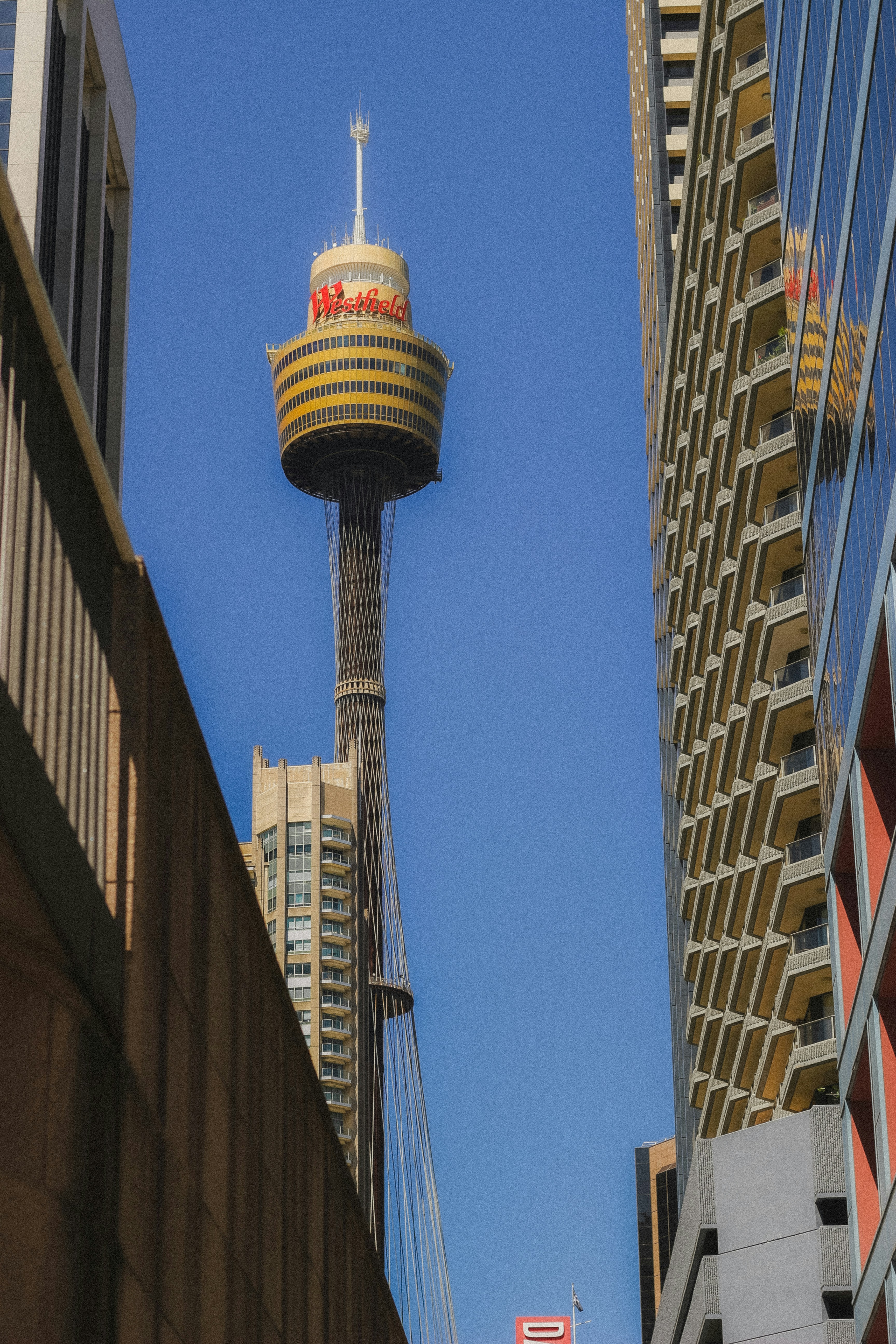 Tall observation tower between modern buildings