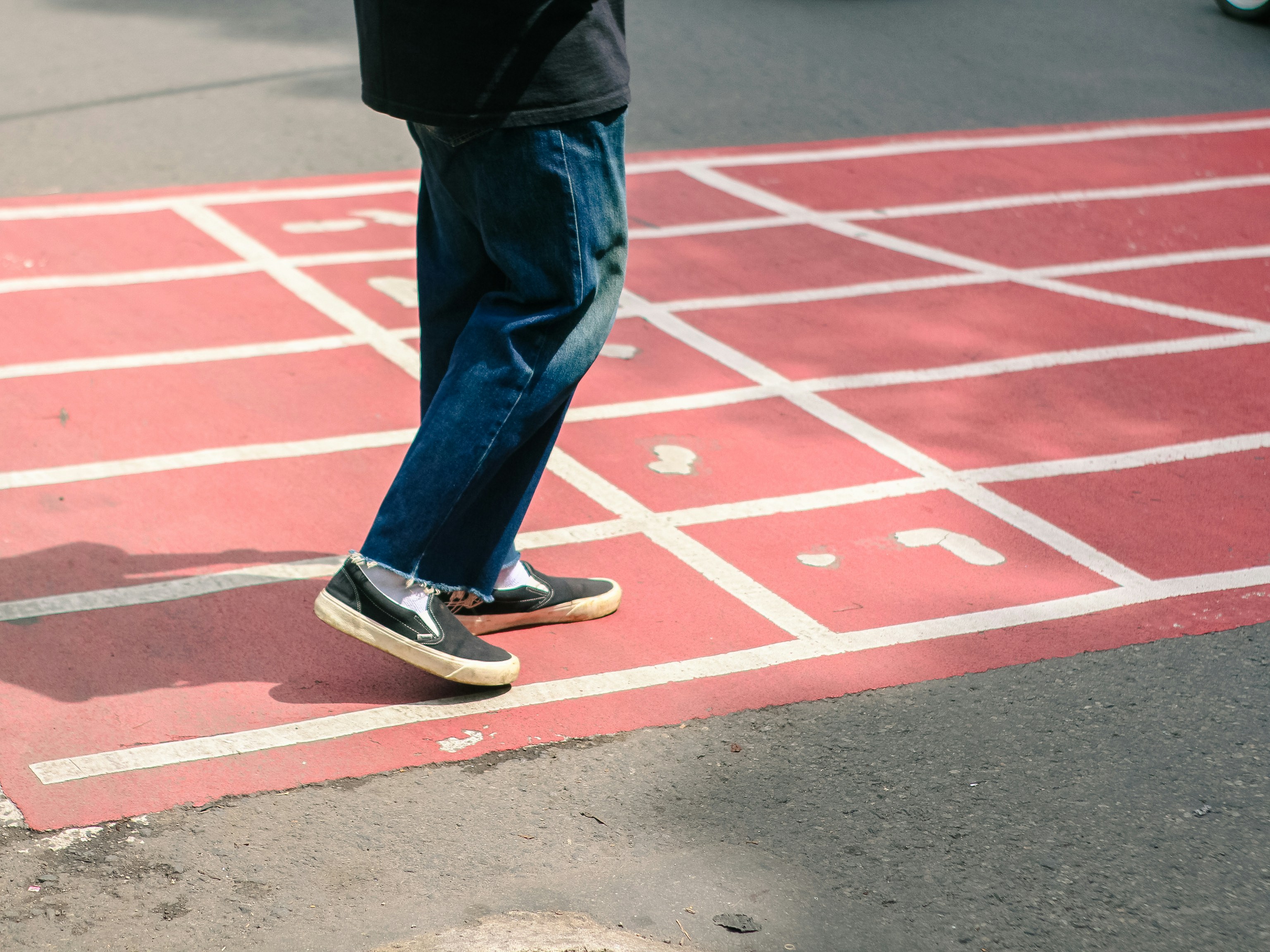 Person walking on a hopscotch court