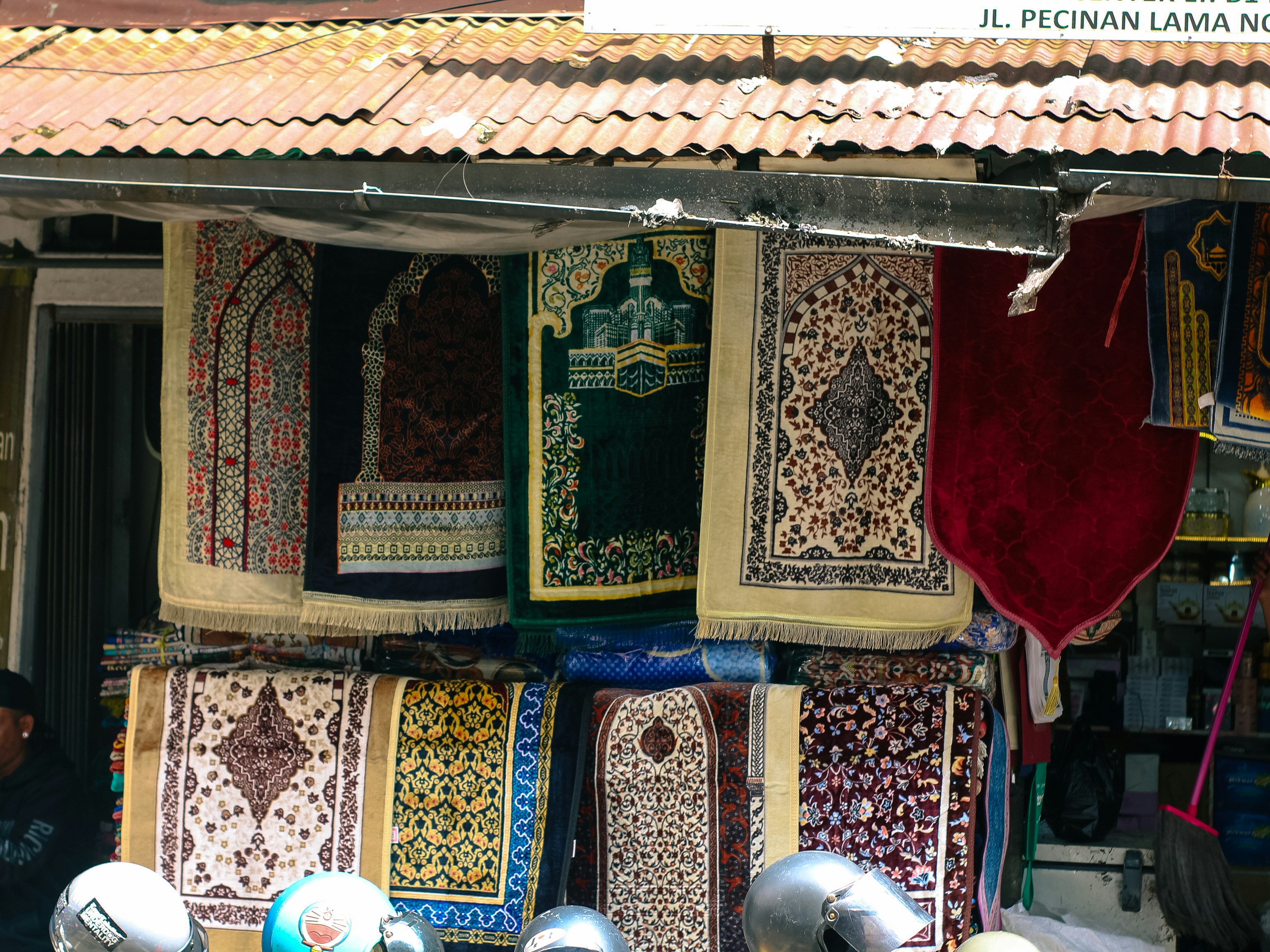 Prayer rugs displayed for sale outside a shop
