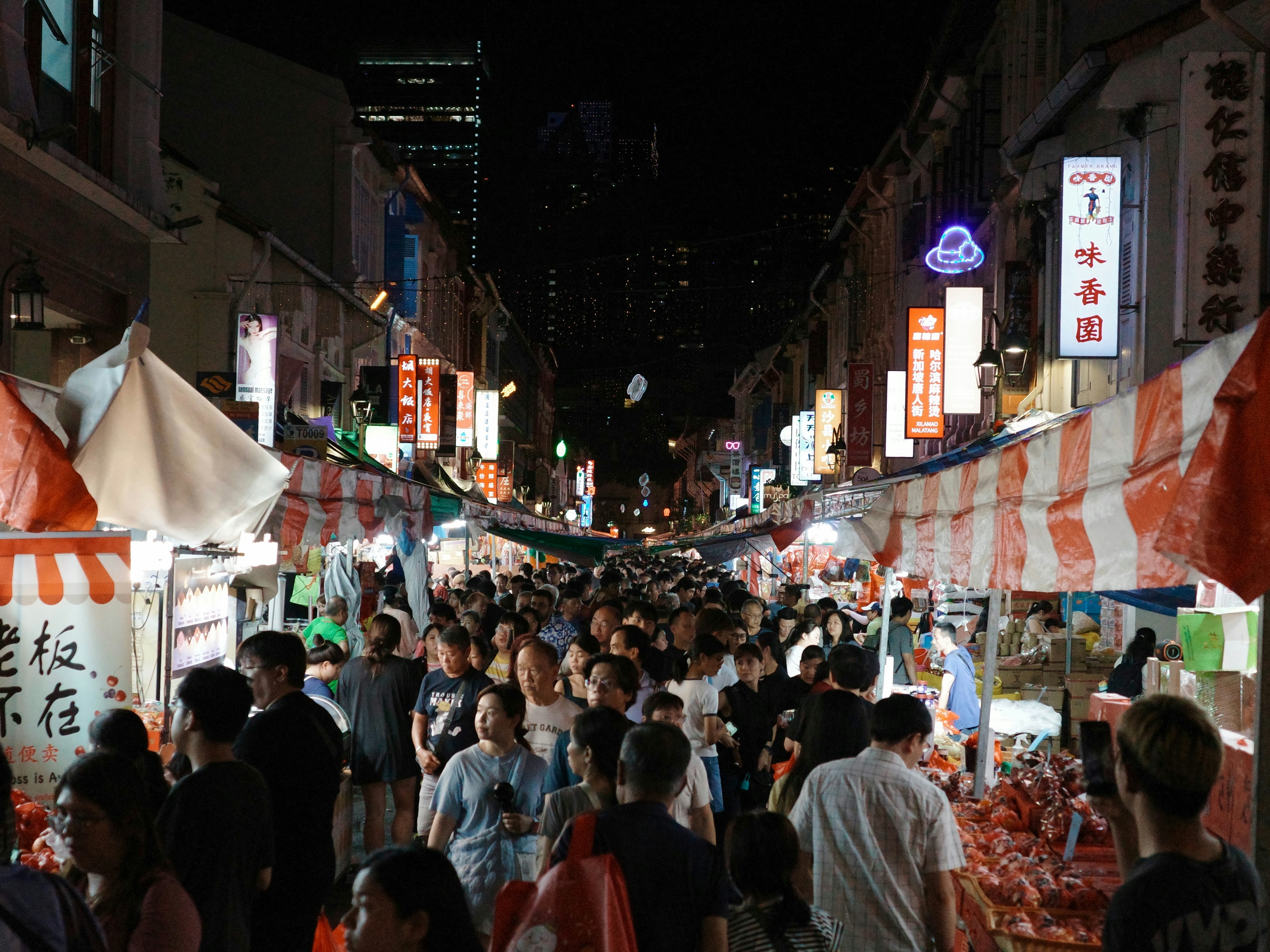Crowded night market street scene in Chinatown, Singapore