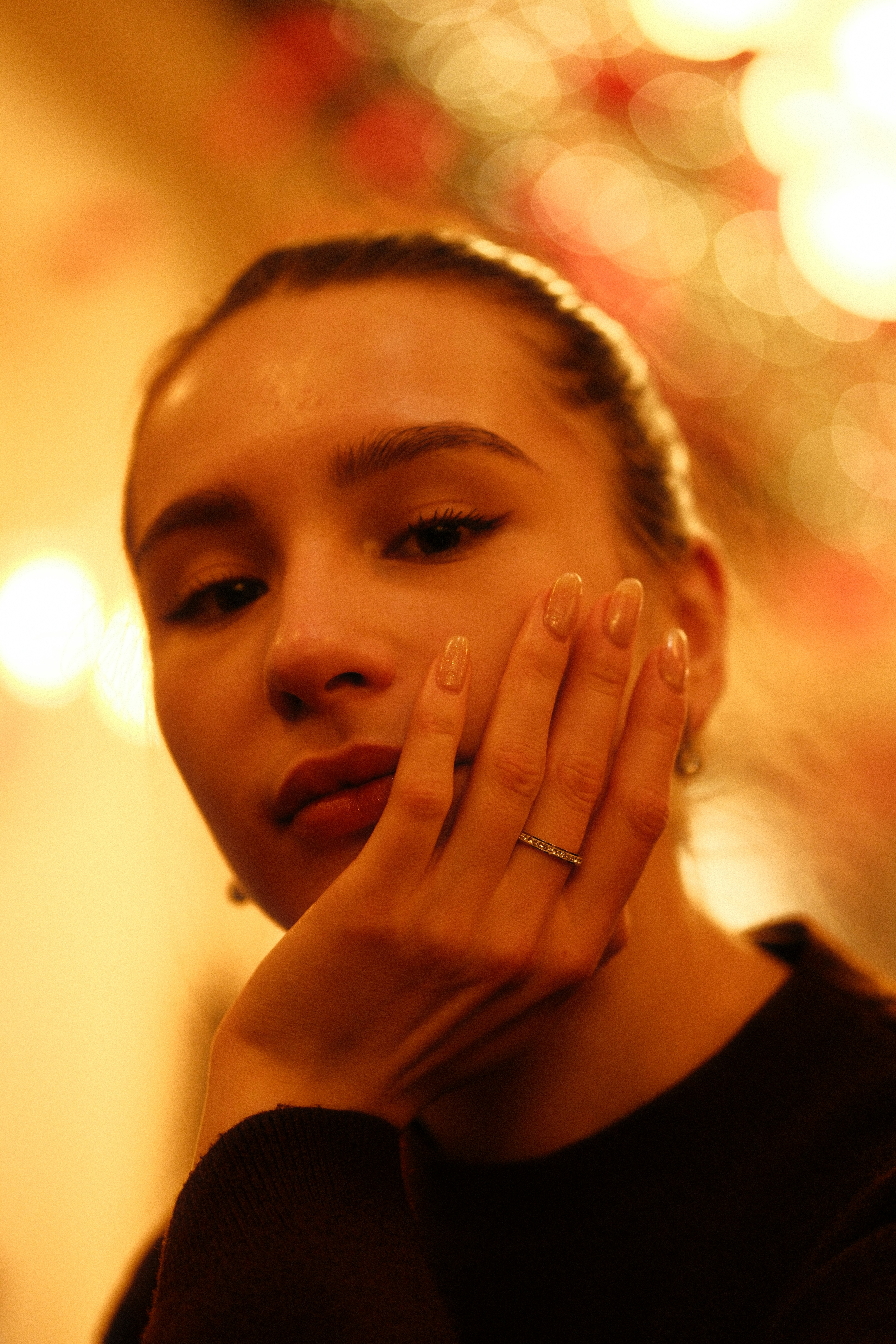Young woman resting her chin on hand