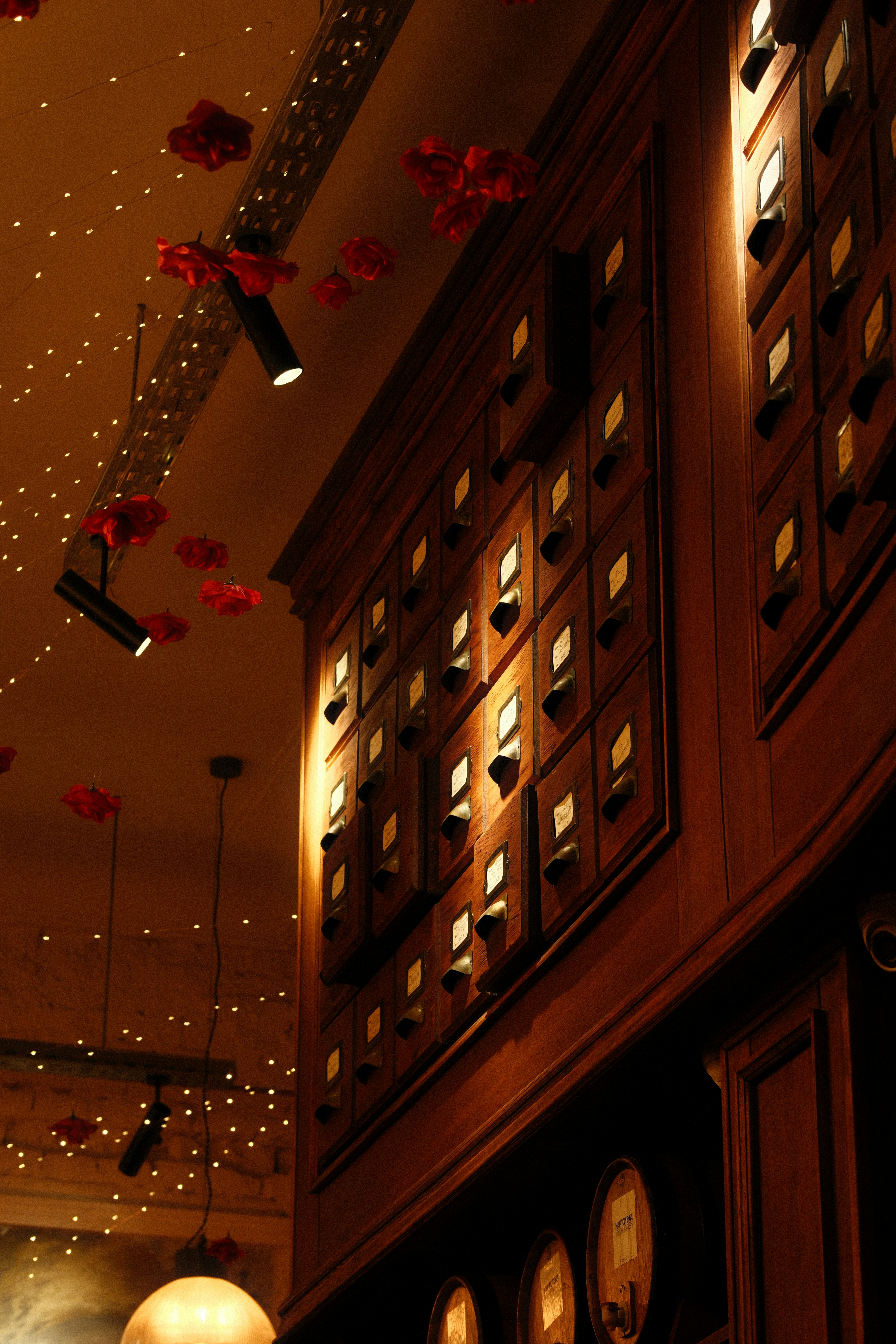 Wooden cabinet with many small drawers and decorative lights.