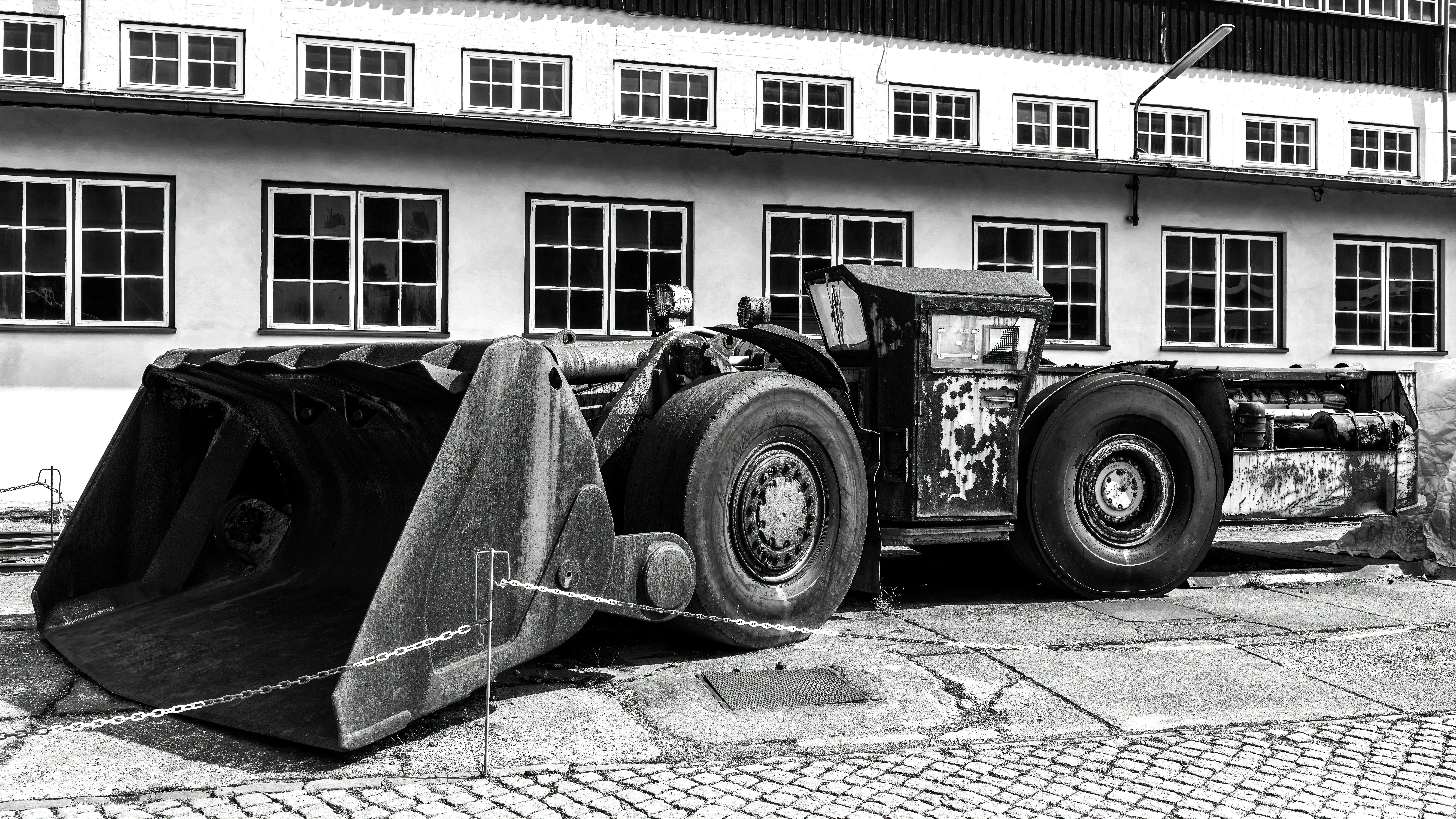 Large front loader parked outside a building