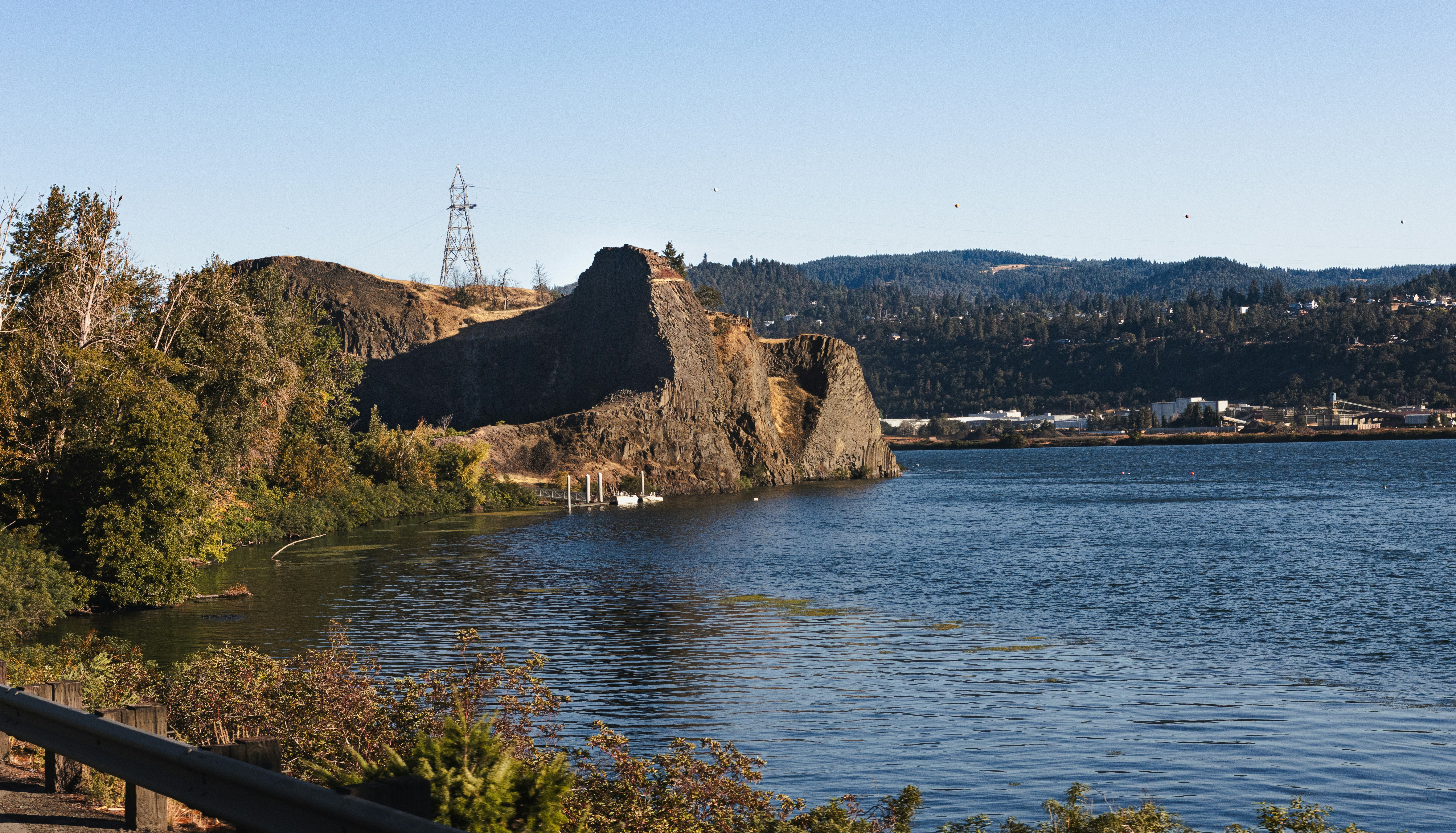 Rocky outcrop on the edge of a calm blue lake.
